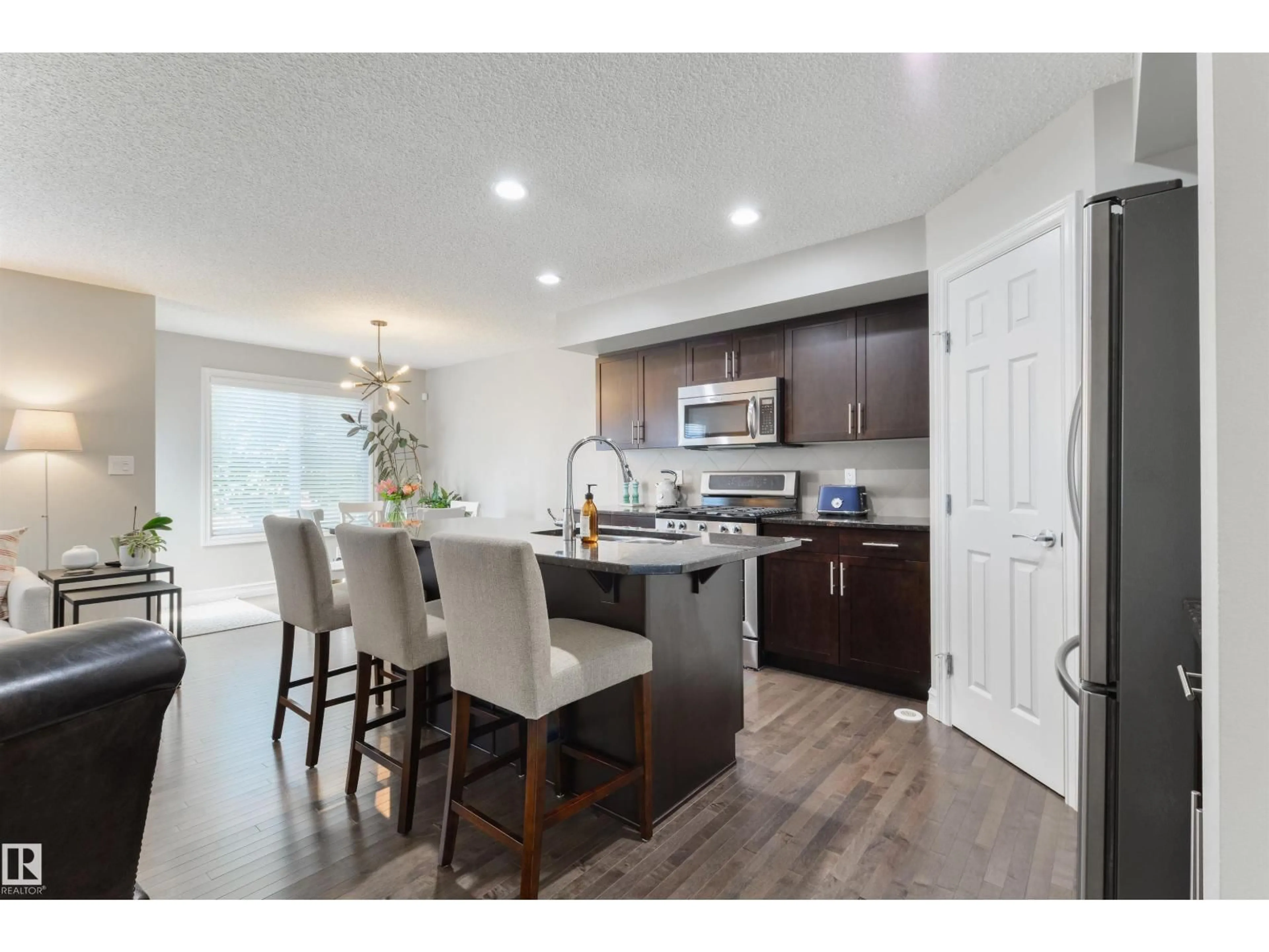Open concept kitchen, wood/laminate floor for SW - 1126 162 ST, Edmonton Alberta T6W2L1