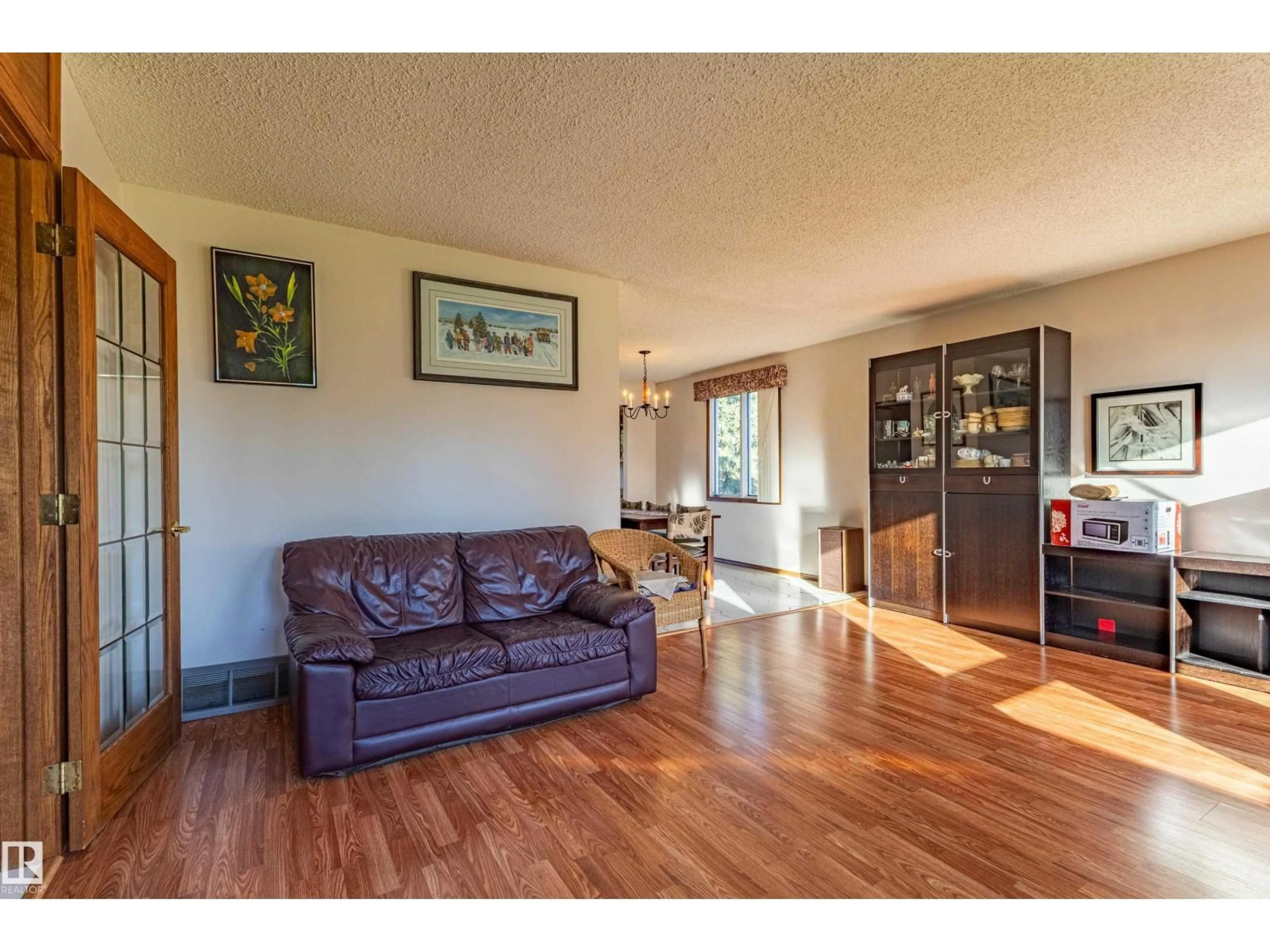 Living room with furniture, wood/laminate floor for 8743 179 ST, Edmonton Alberta T5T0X4