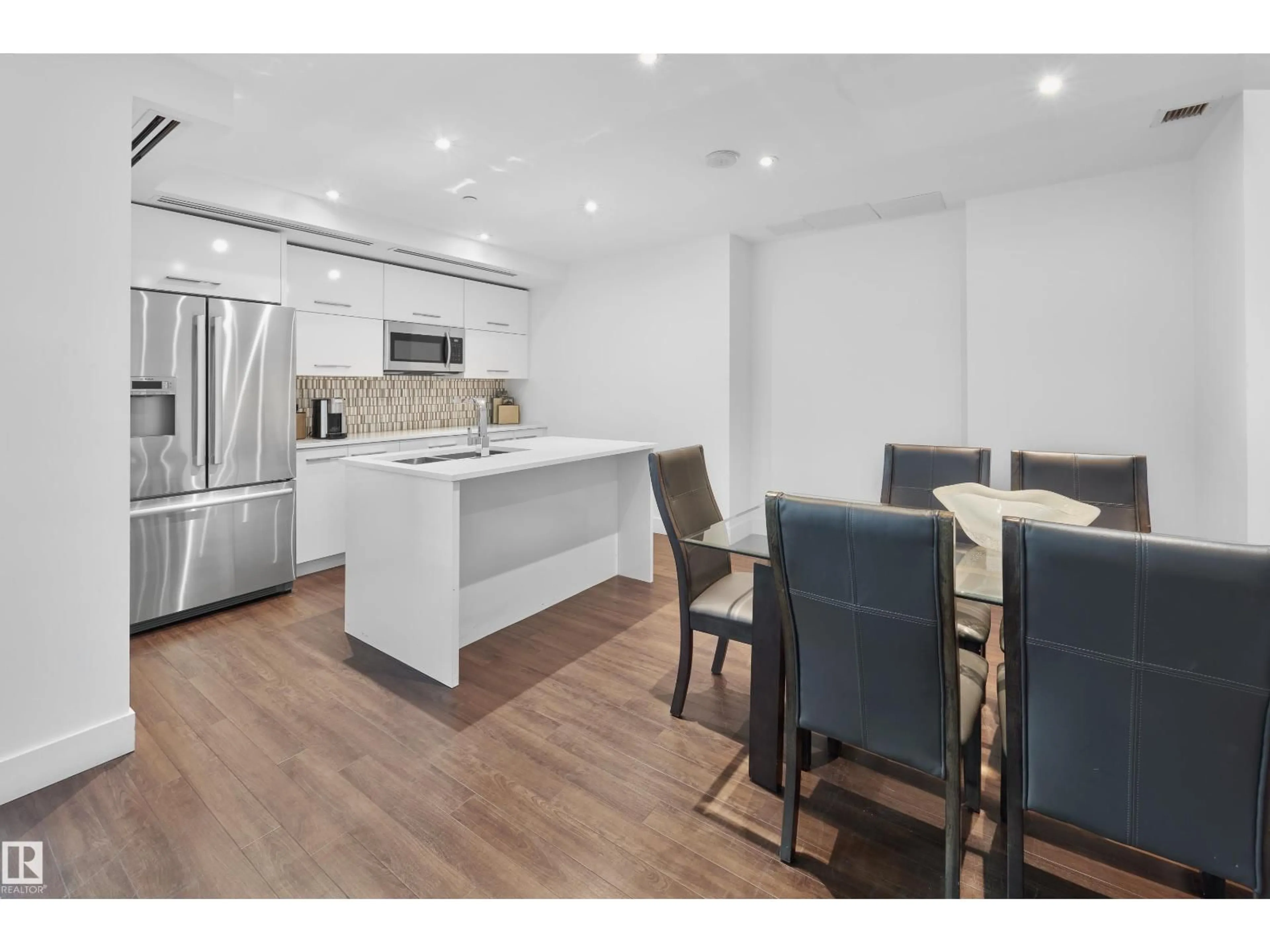 Open concept kitchen, wood/laminate floor for 502 - 11969 JASPER AV, Edmonton Alberta T5K0P1