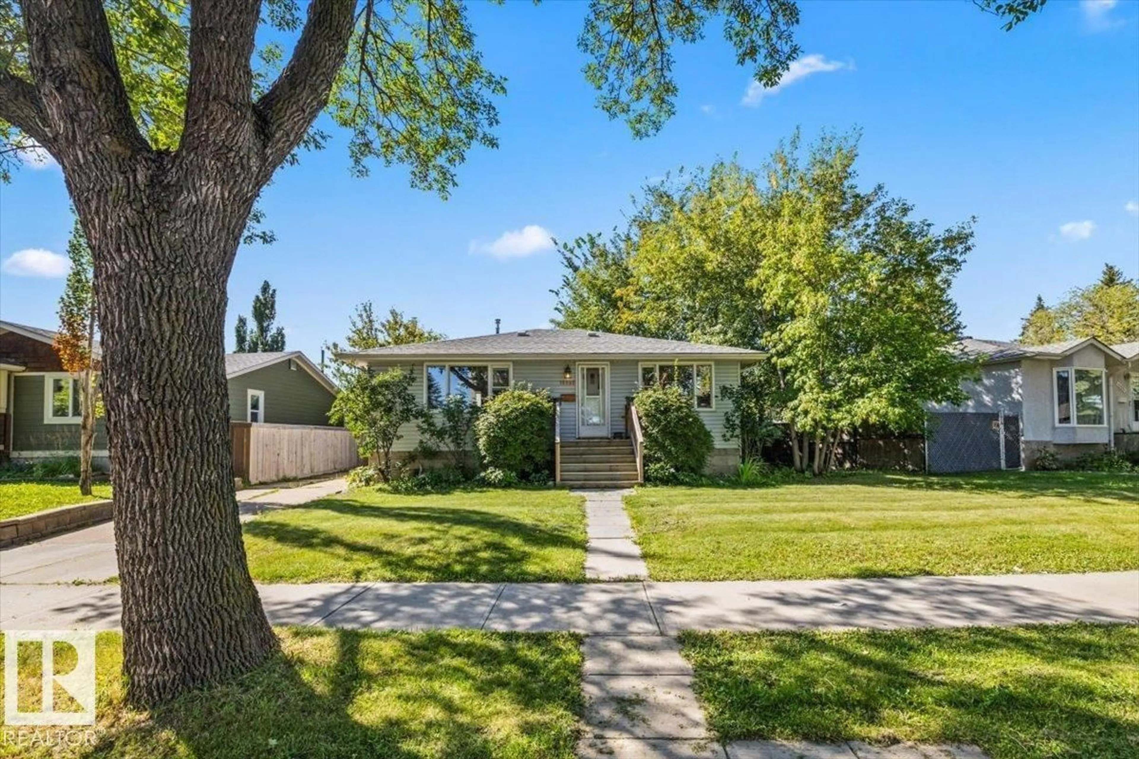 Home with vinyl exterior material, street for 10990 135 ST, Edmonton Alberta T5M1K2