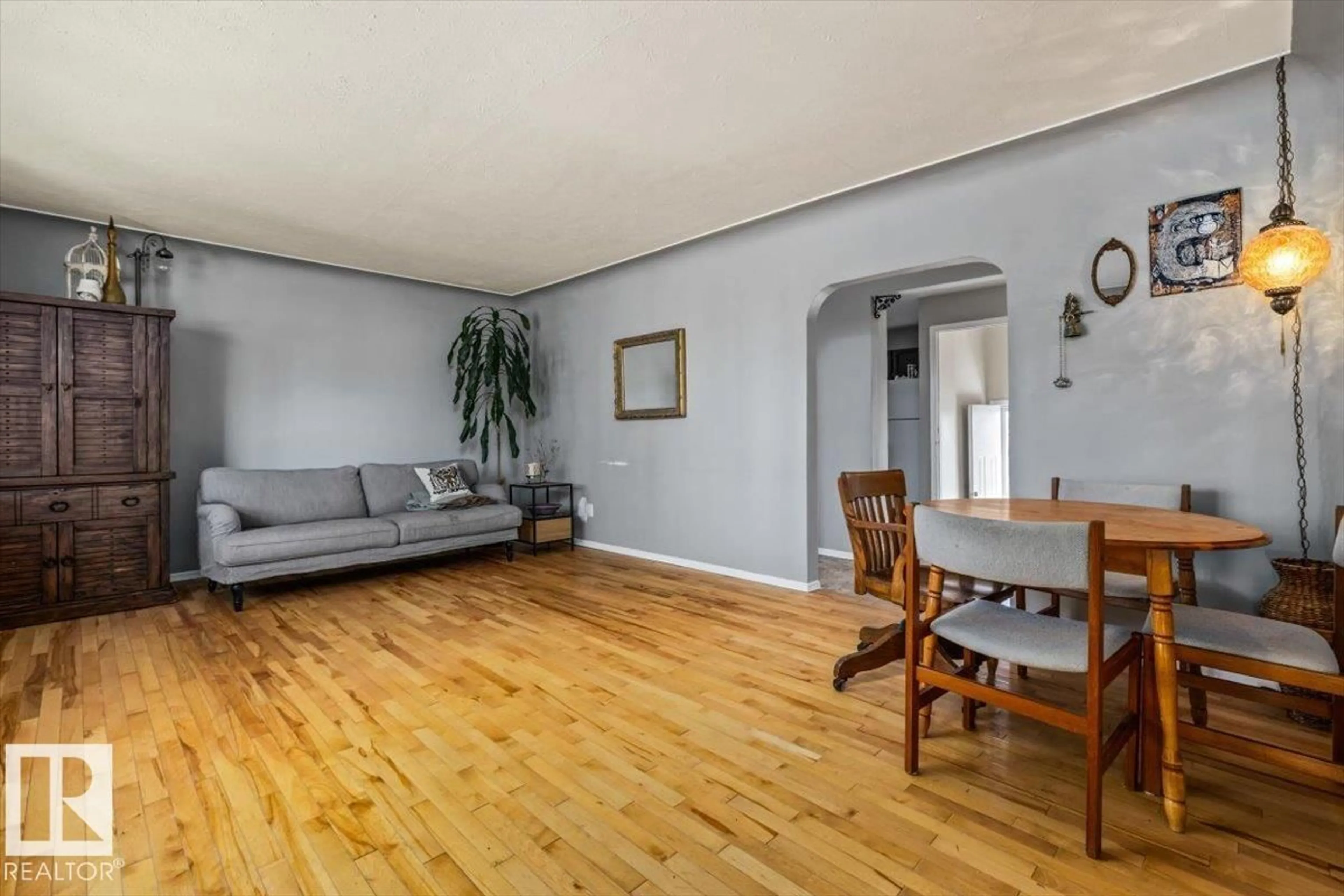 Living room with furniture, wood/laminate floor for 10990 135 ST, Edmonton Alberta T5M1K2