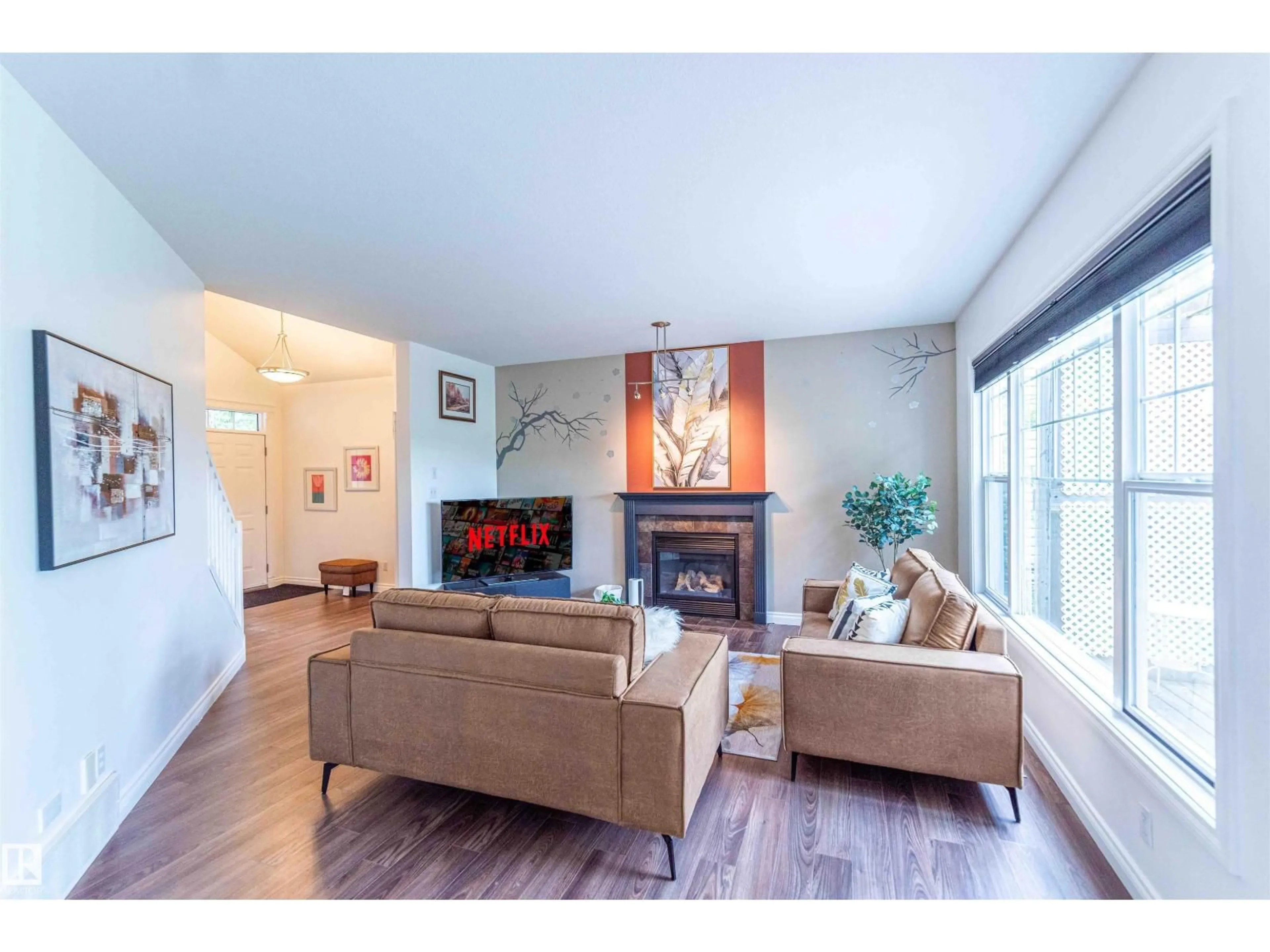 Living room with furniture, wood/laminate floor for 5092 THIBAULT WY, Edmonton Alberta T6R3J3