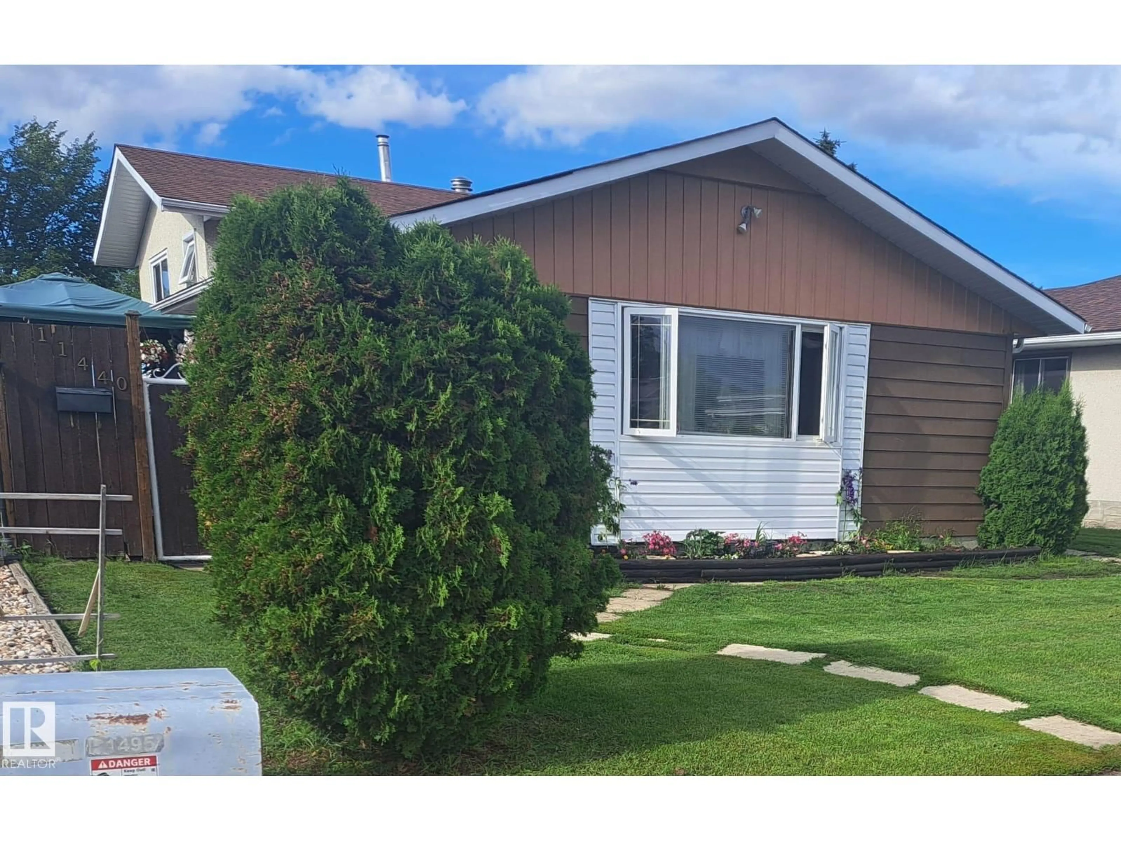 Home with vinyl exterior material, street for 11440 144 AV, Edmonton Alberta T5X1L8