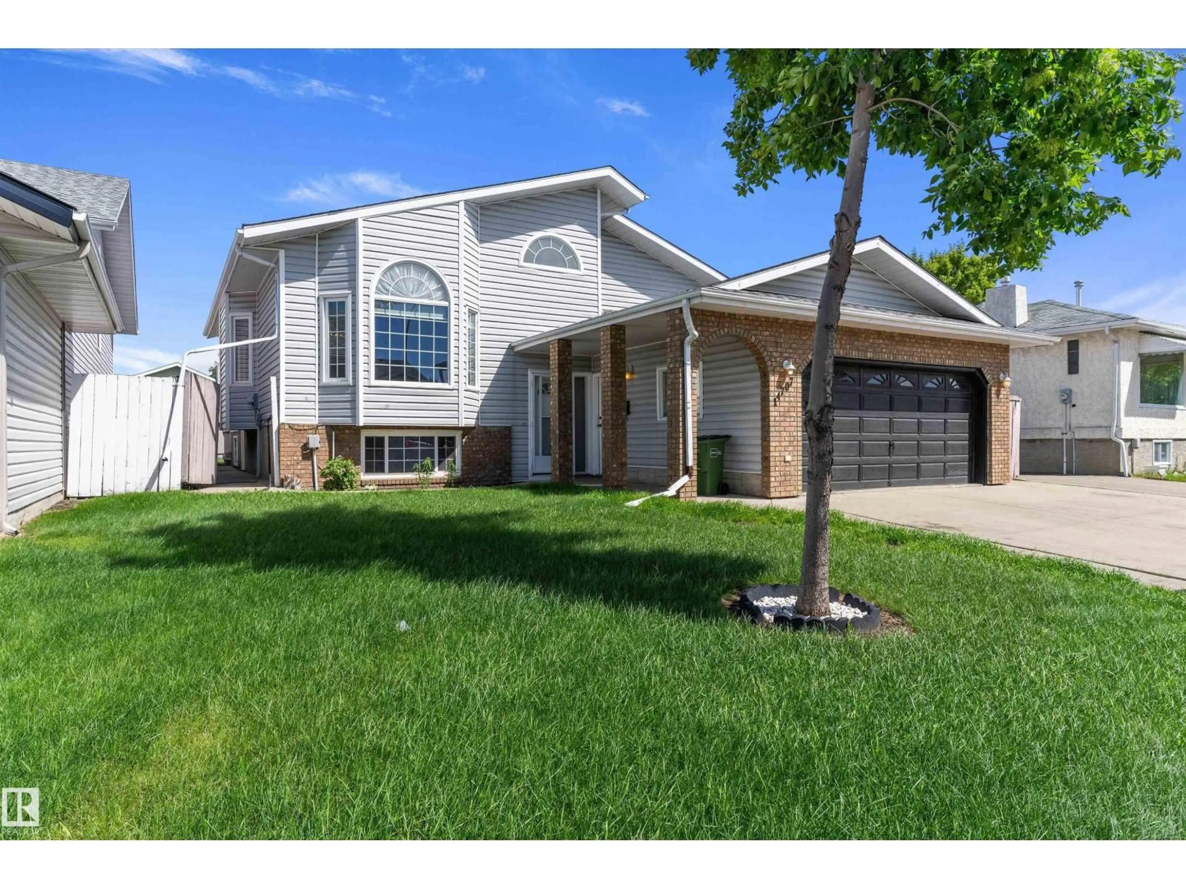 Home with vinyl exterior material, street for 14707 33 ST, Edmonton Alberta T5Y2C9