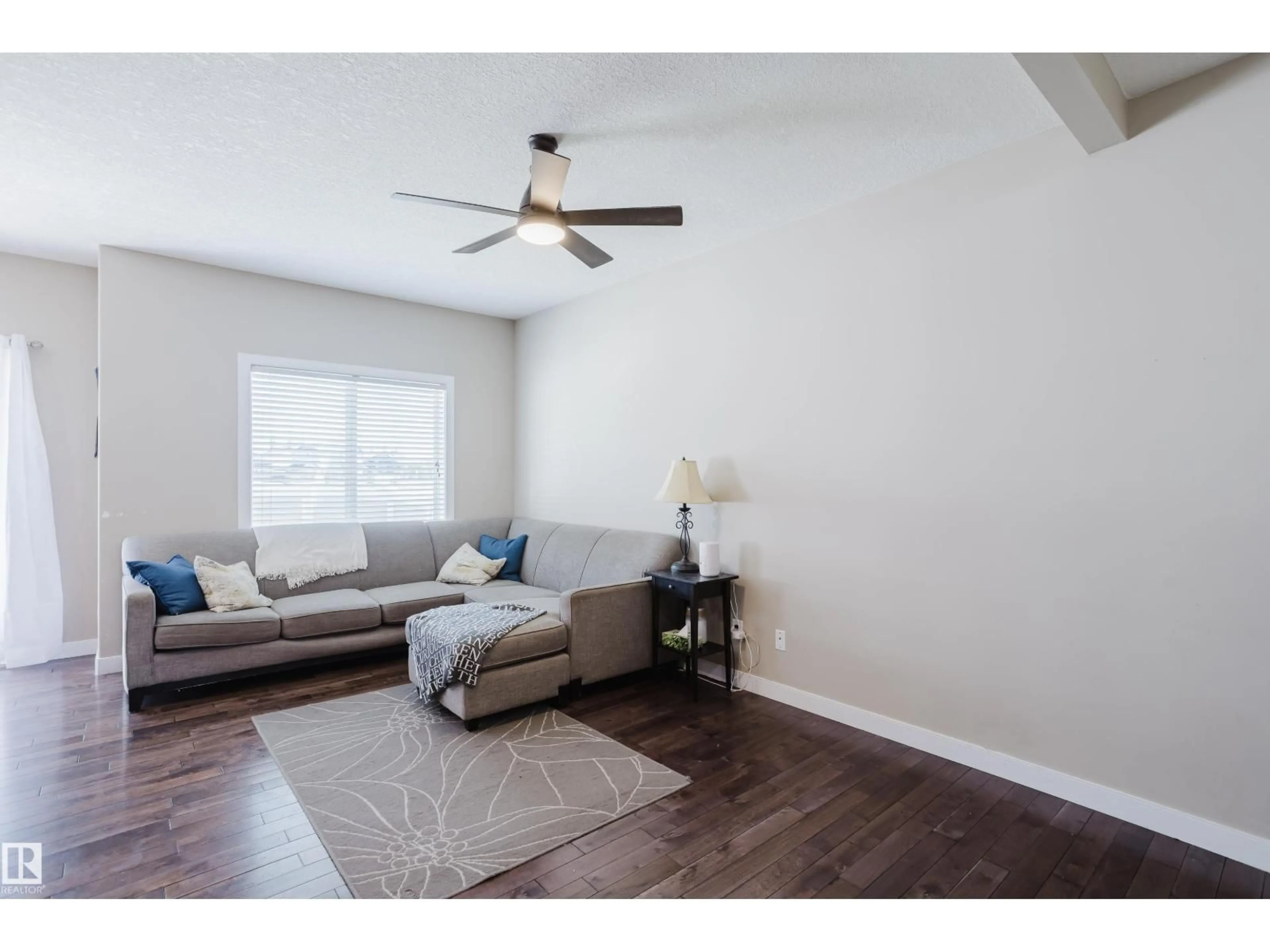 Living room with furniture, wood/laminate floor for 3209 67 ST, Beaumont Alberta T4X0W7