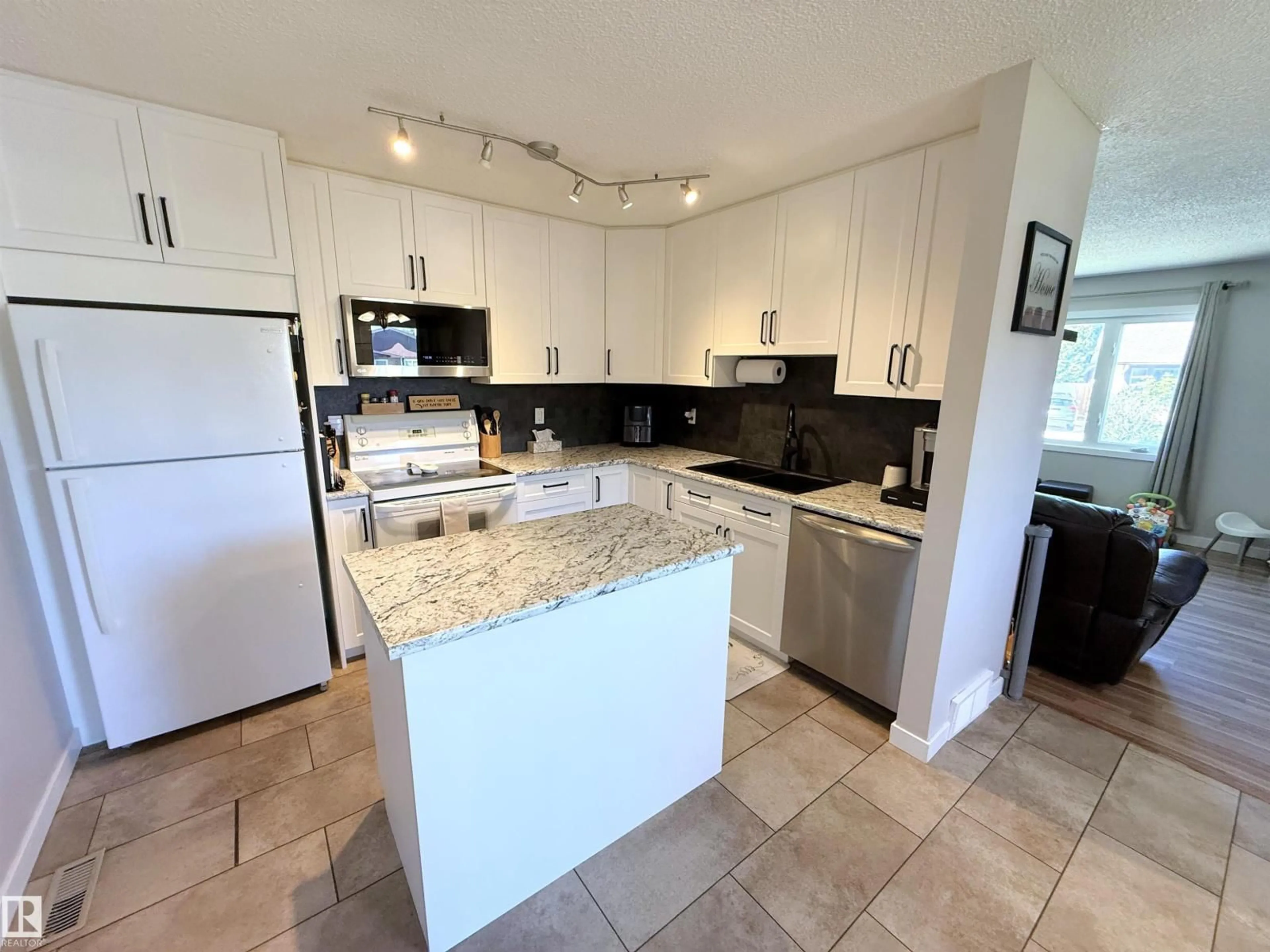 Open concept kitchen, ceramic/tile floor for 10107 171A AV, Edmonton Alberta T5X4L3
