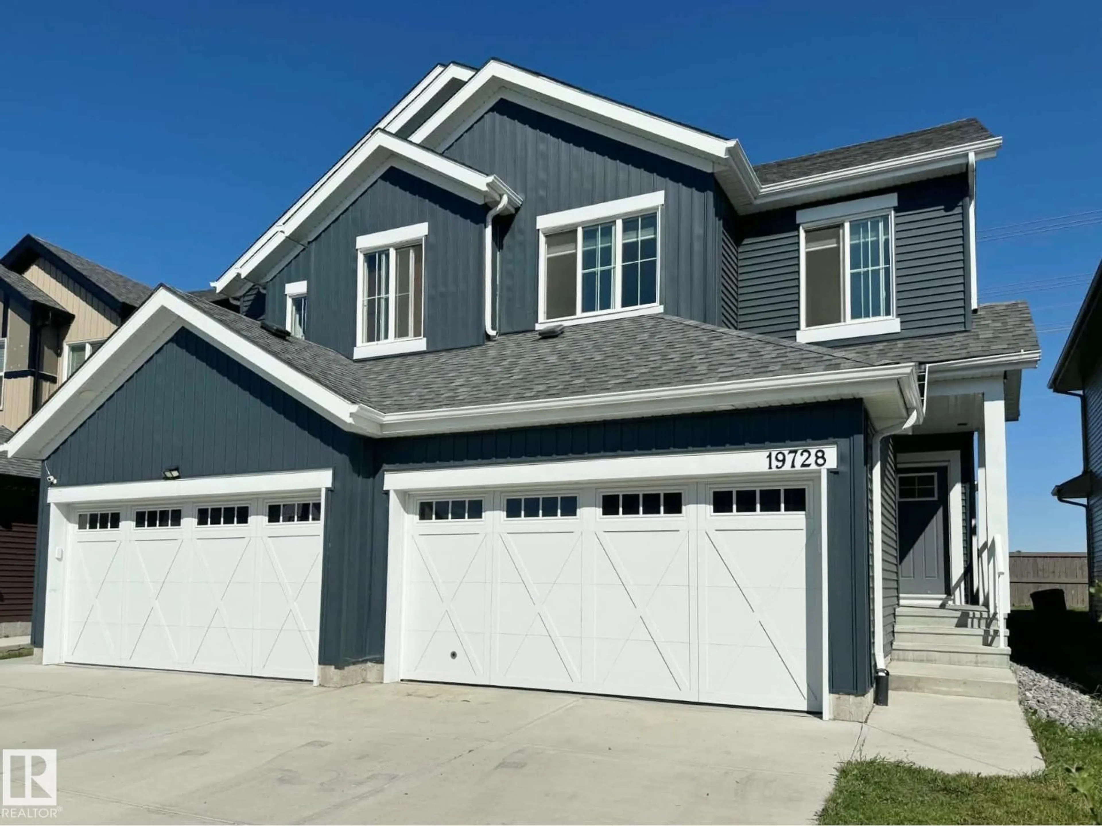 Home with vinyl exterior material, street for 19728 29 AV, Edmonton Alberta T6M1M2