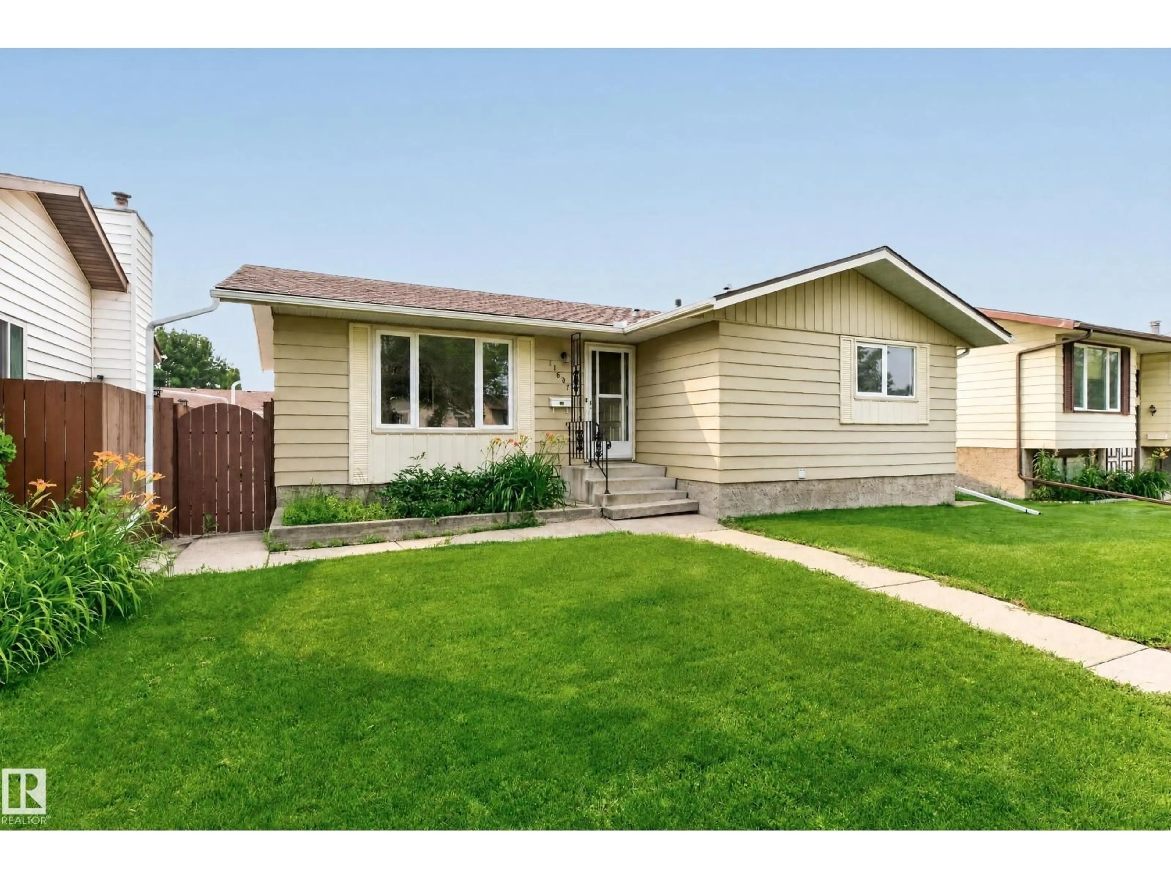 Home with vinyl exterior material, street for 11607 139 AV, Edmonton Alberta T5X3L3