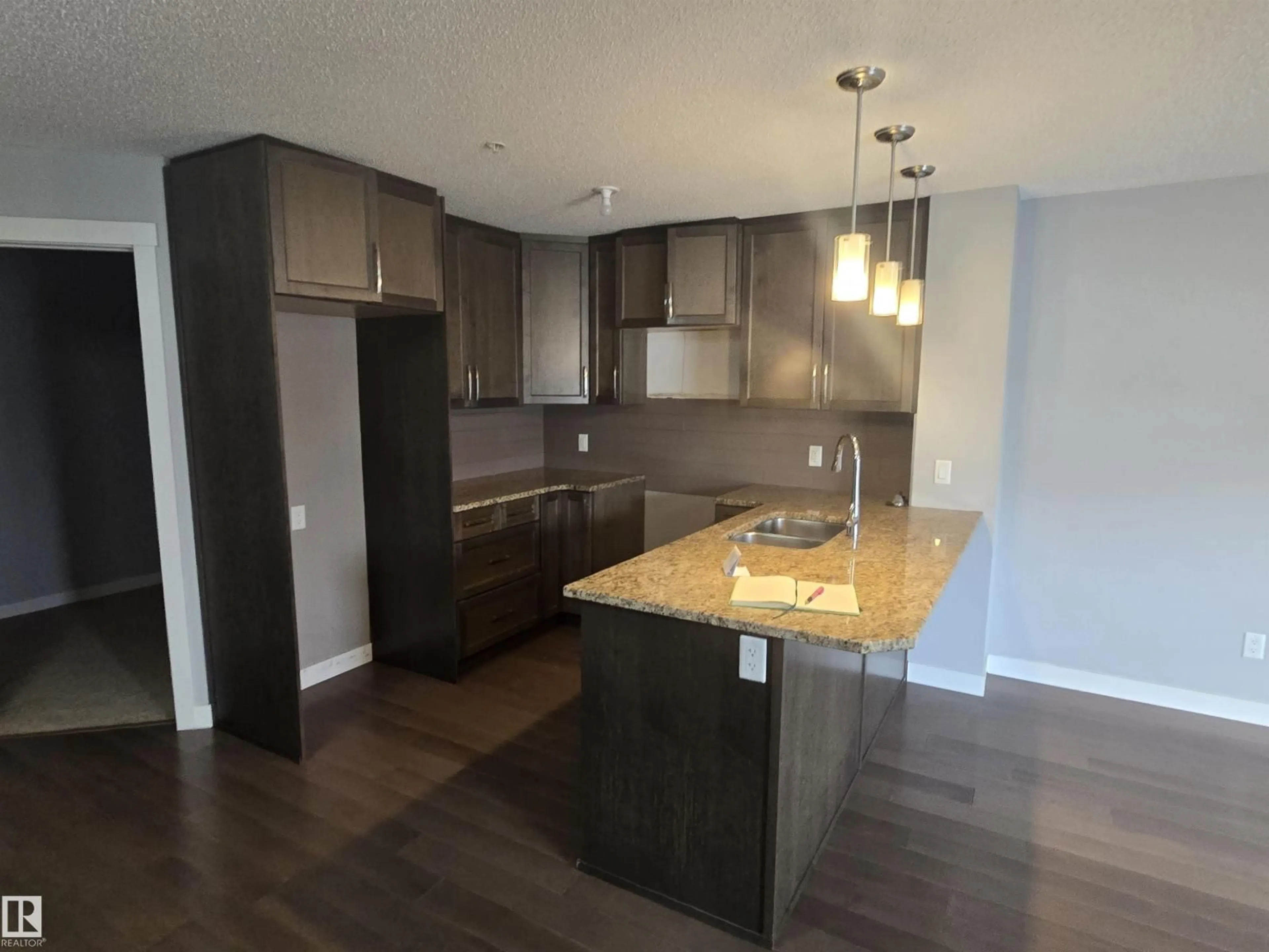 Open concept kitchen, wood/laminate floor for NW - 2207 44 AV, Edmonton Alberta T6T0W6
