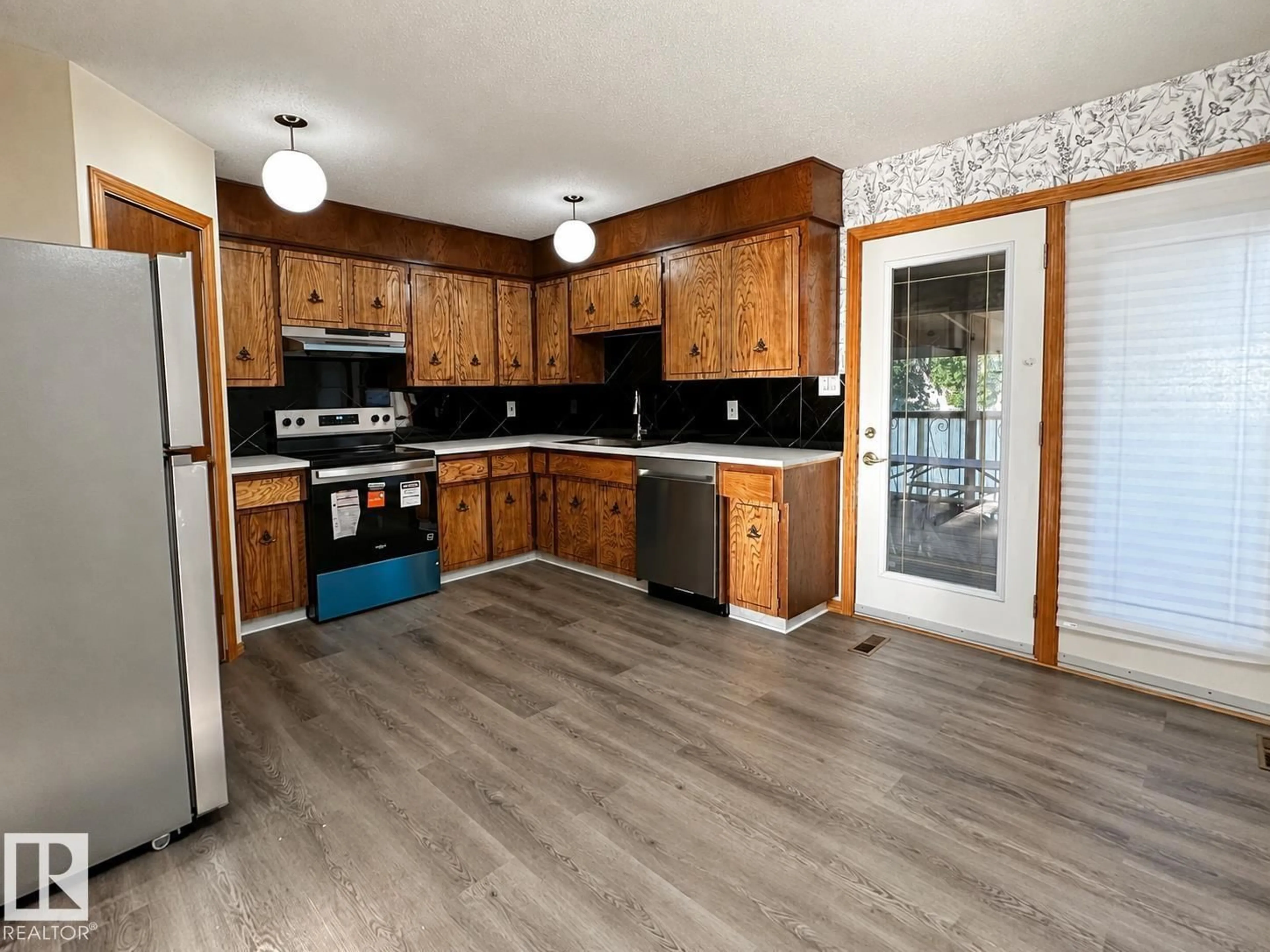Open concept kitchen, wood/laminate floor for 13110 31 ST, Edmonton Alberta T5A3A4