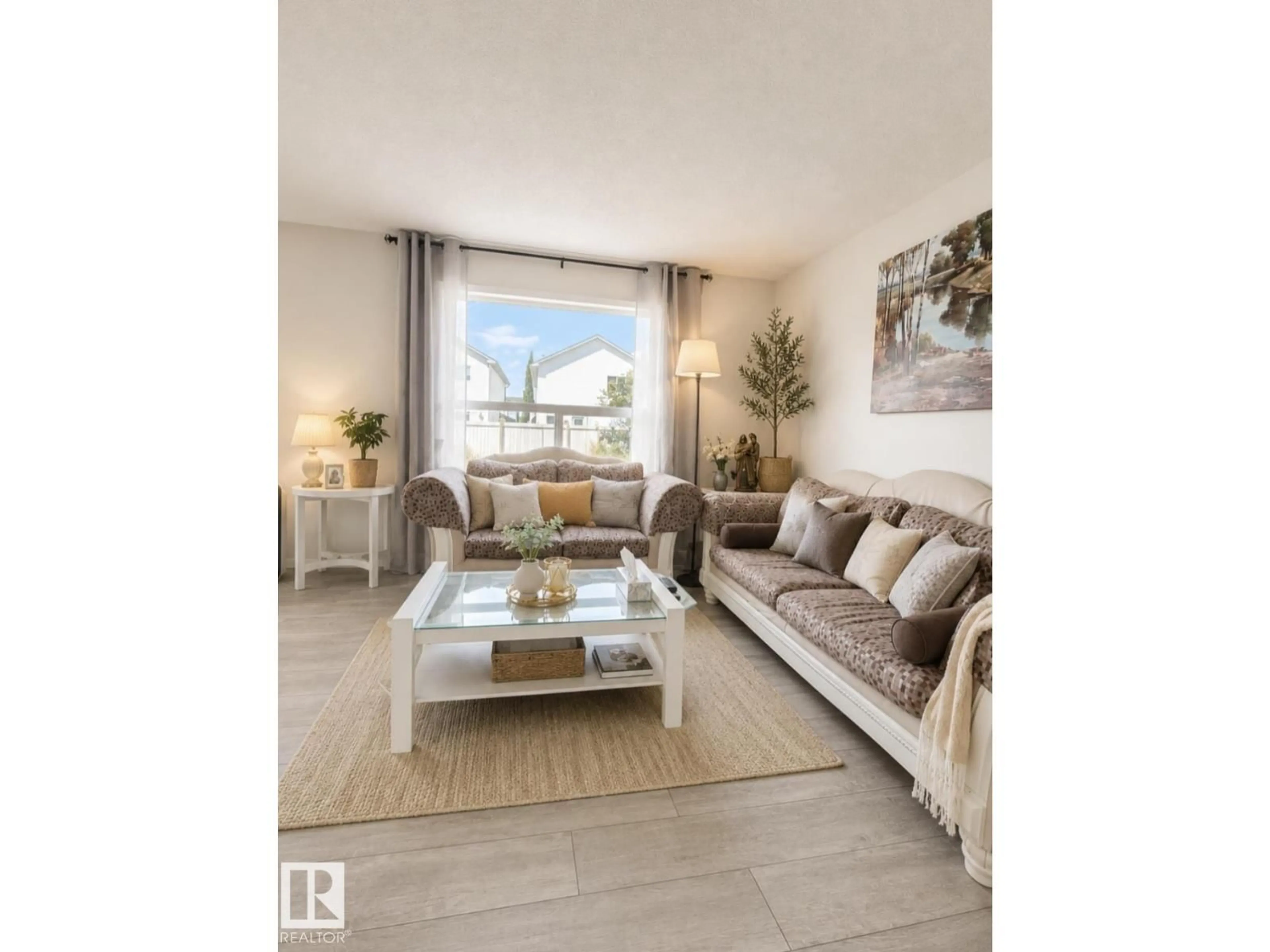 Living room with furniture, wood/laminate floor for 3236 27 AV, Edmonton Alberta T6T1P8