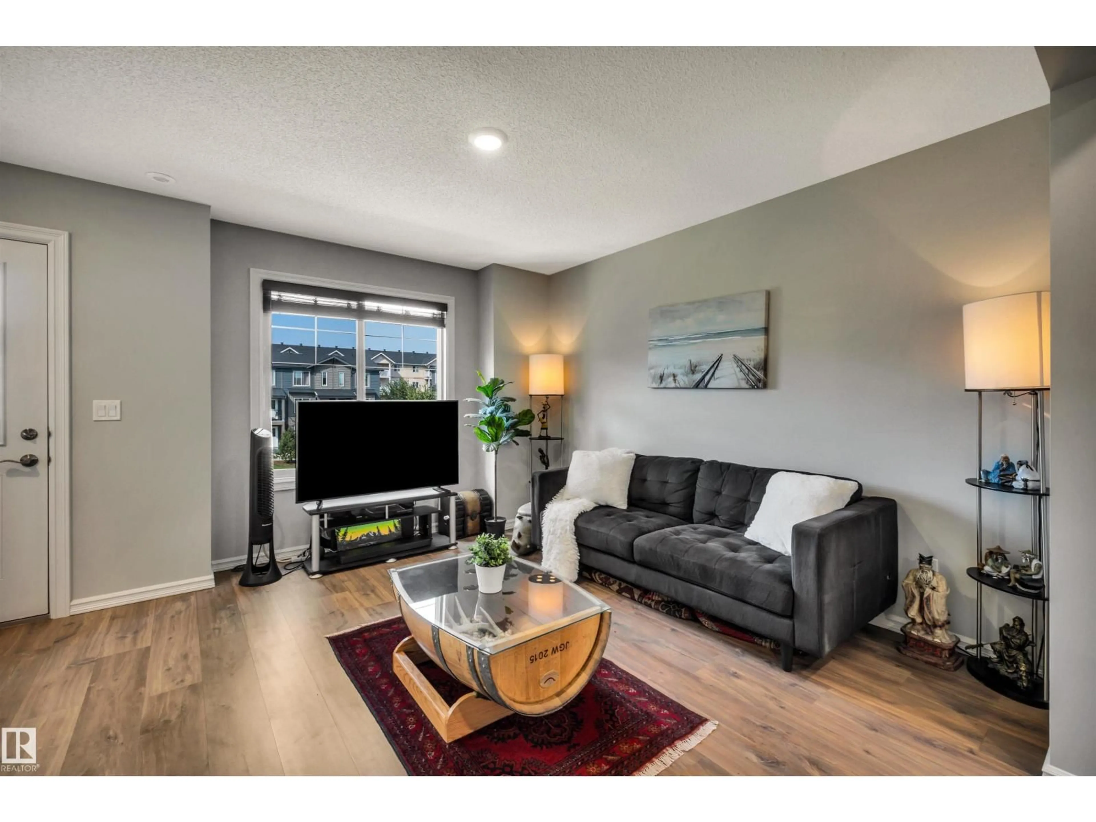 Living room with furniture, wood/laminate floor for #33 - 3025 151 AV, Edmonton Alberta T5Y3W4