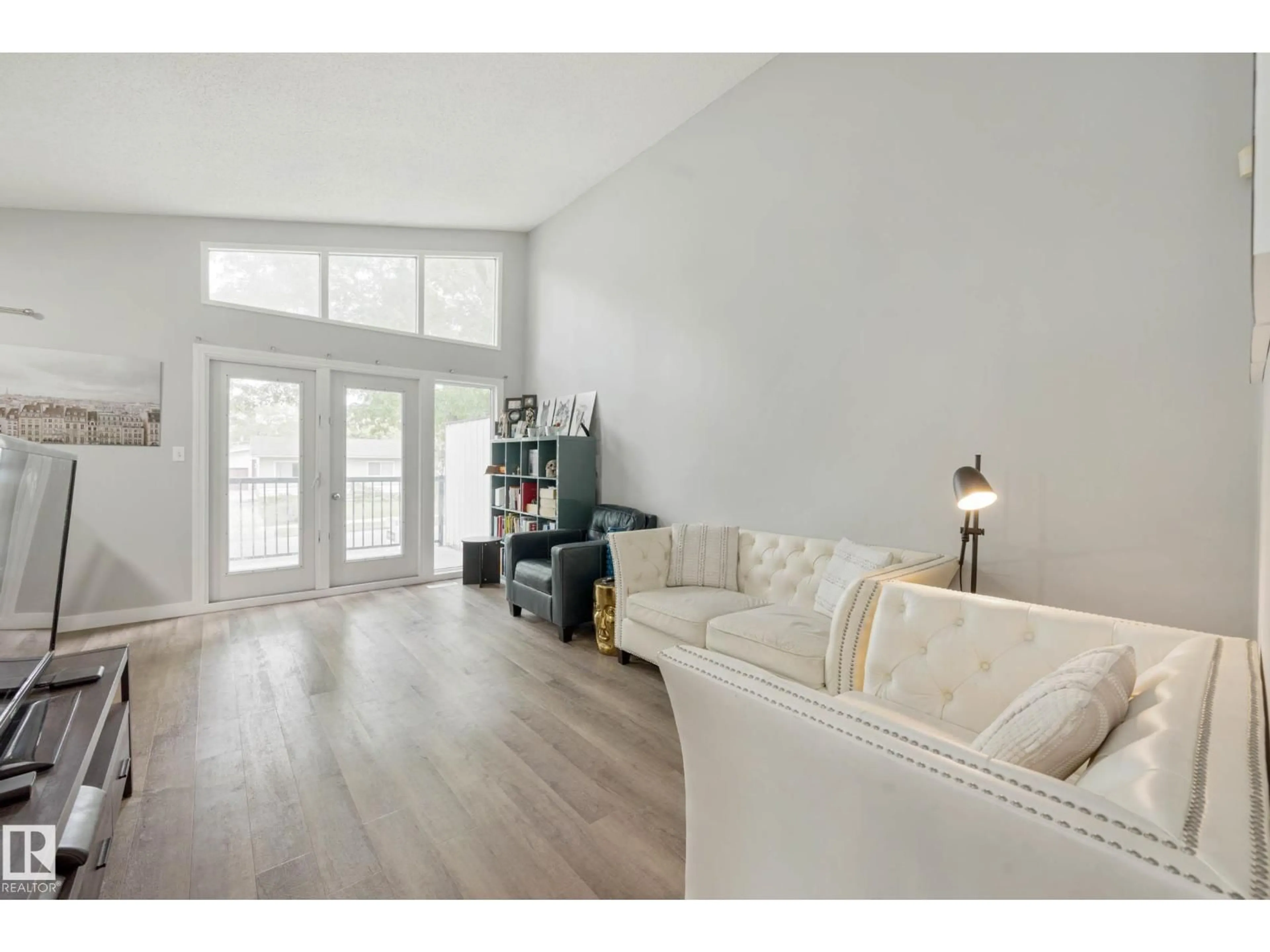 Living room with furniture, wood/laminate floor for NW - 11828 & 11830 45 ST, Edmonton Alberta T5W2T4