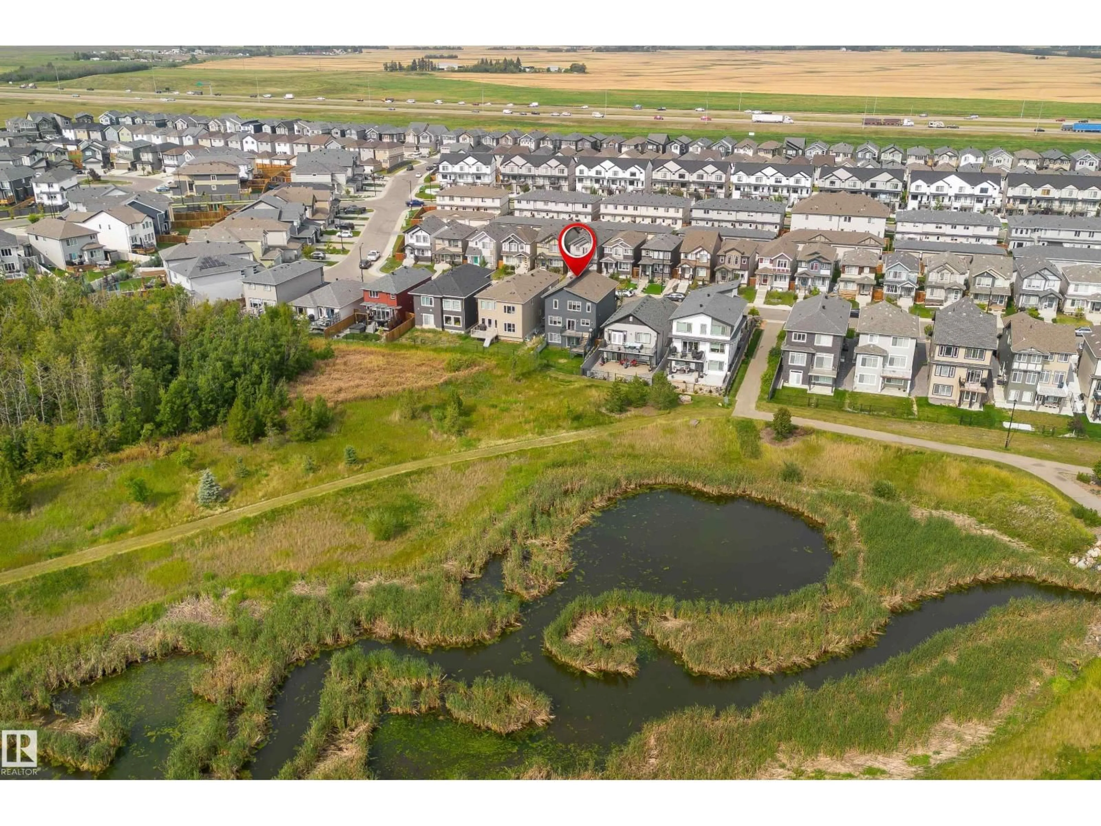 A pic from outside/outdoor area/front of a property/back of a property/a pic from drone, water/lake/river/ocean view for NW - 4659 175 AV, Edmonton Alberta T5Y3Z8