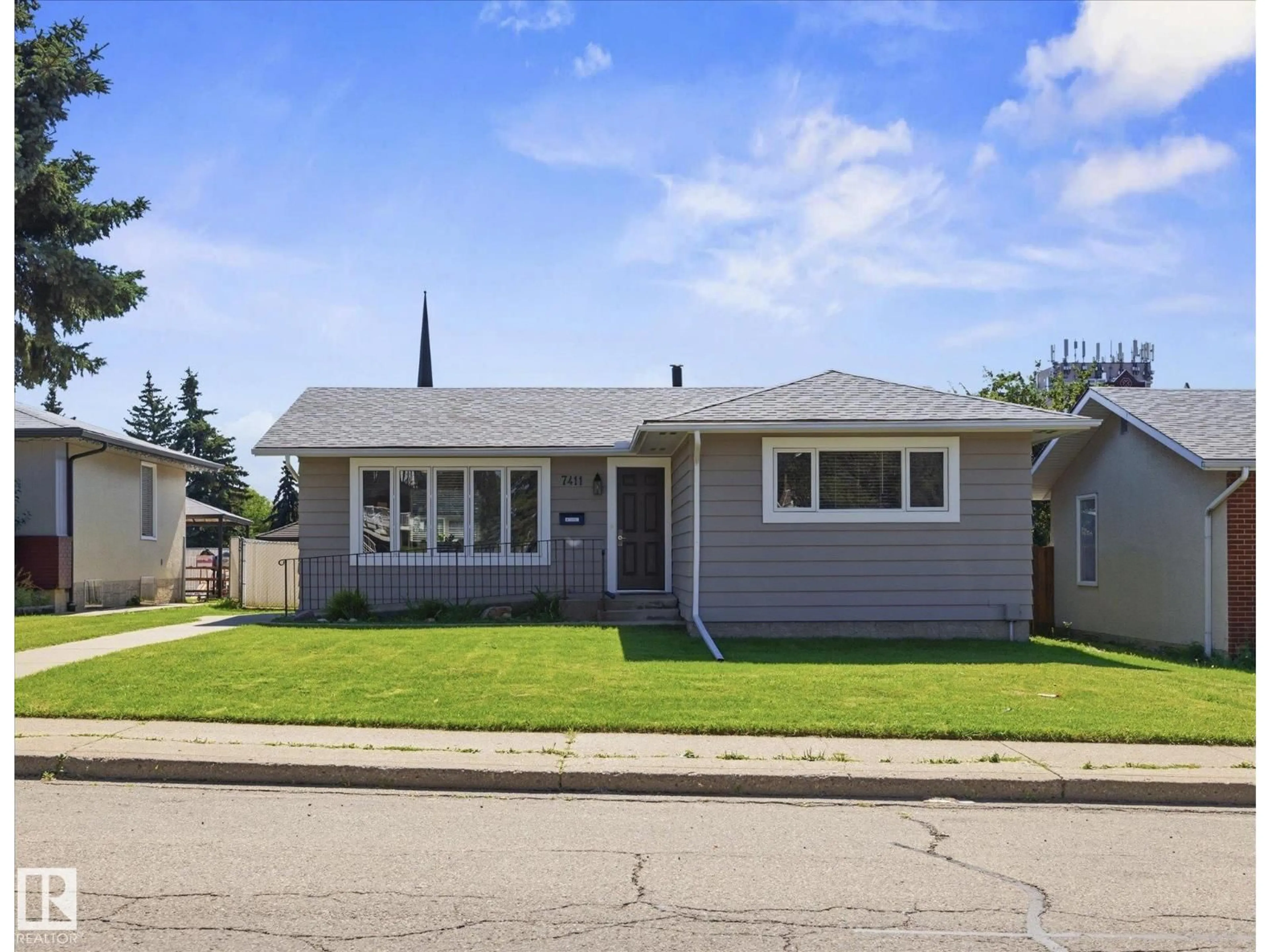 Home with vinyl exterior material, street for 7411 141 AV, Edmonton Alberta T5C2N4