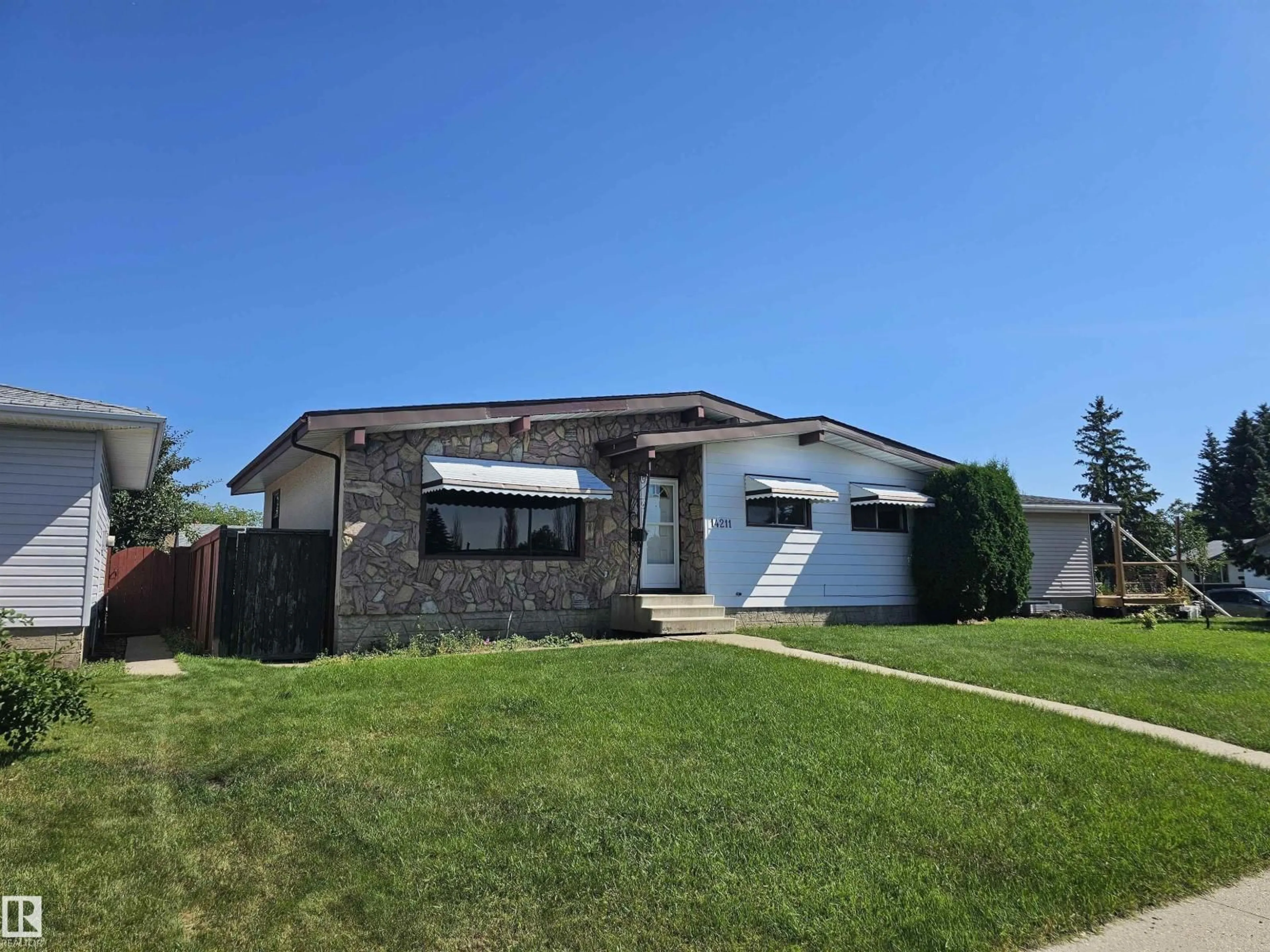 Home with vinyl exterior material, street for 14211 77 ST, Edmonton Alberta T5C1E5