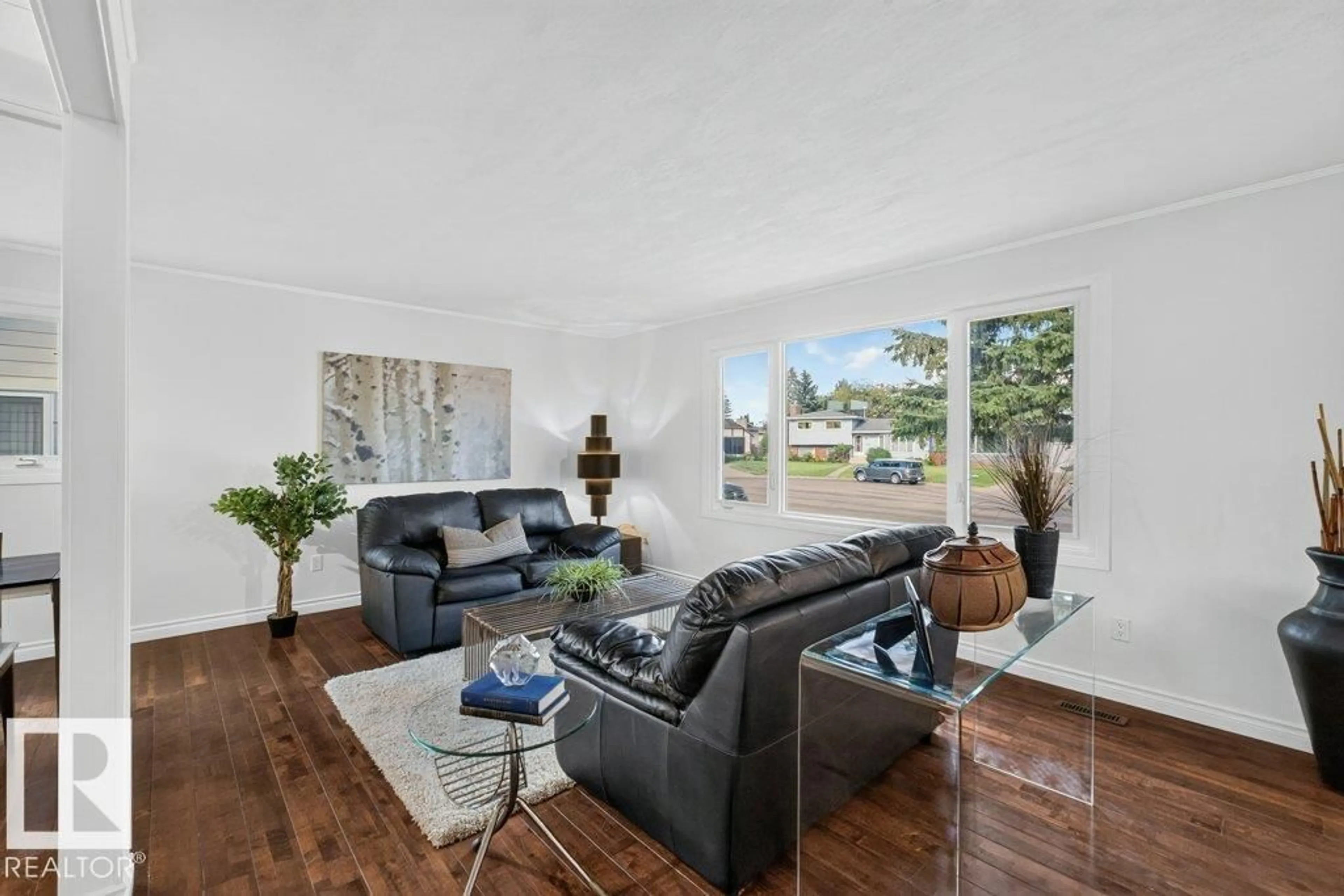 Living room with furniture, wood/laminate floor for 8720 26 AV, Edmonton Alberta T6K2X2