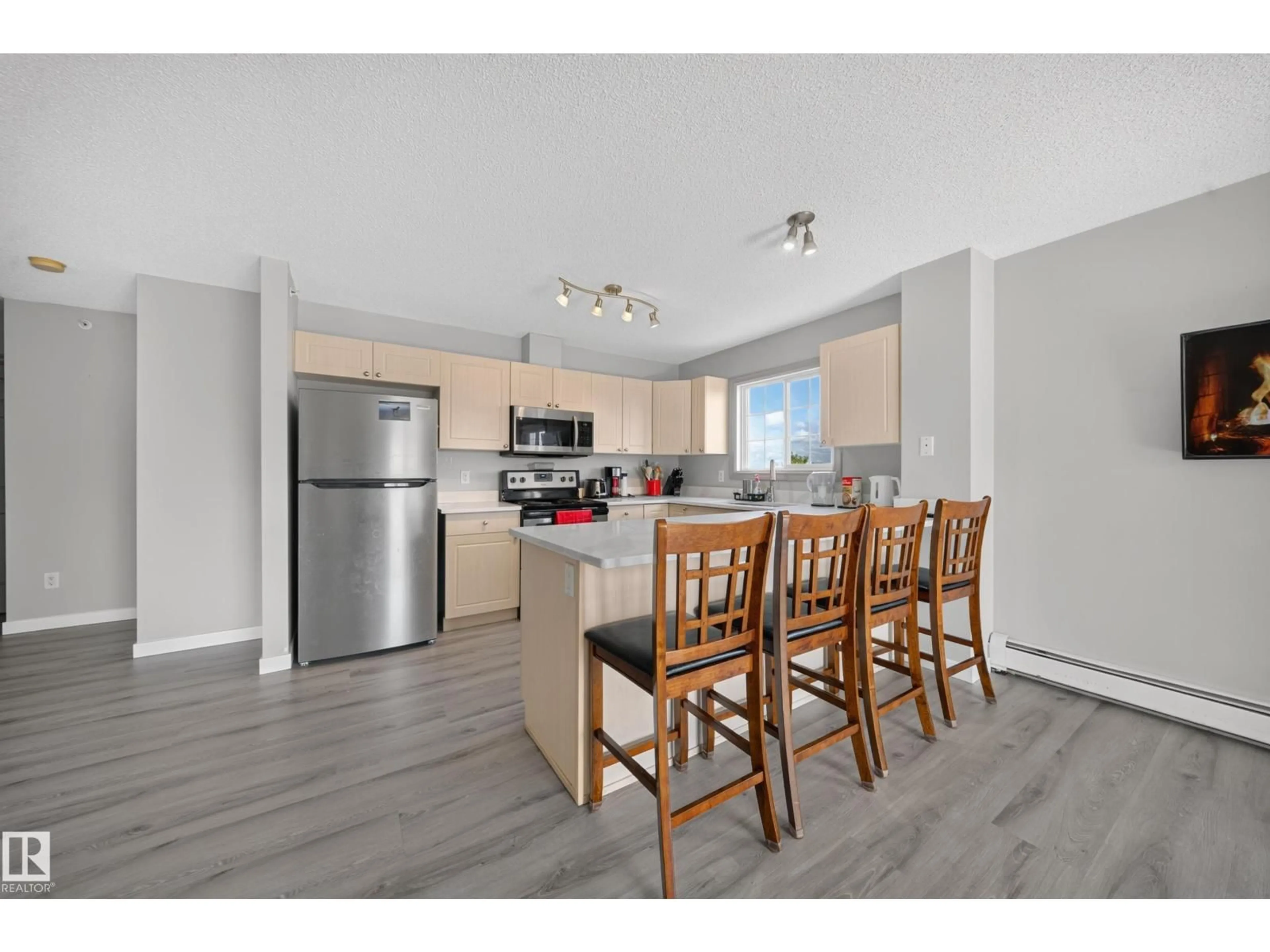 Open concept kitchen, wood/laminate floor for #419 - 4407 23 ST, Edmonton Alberta T6T0B6