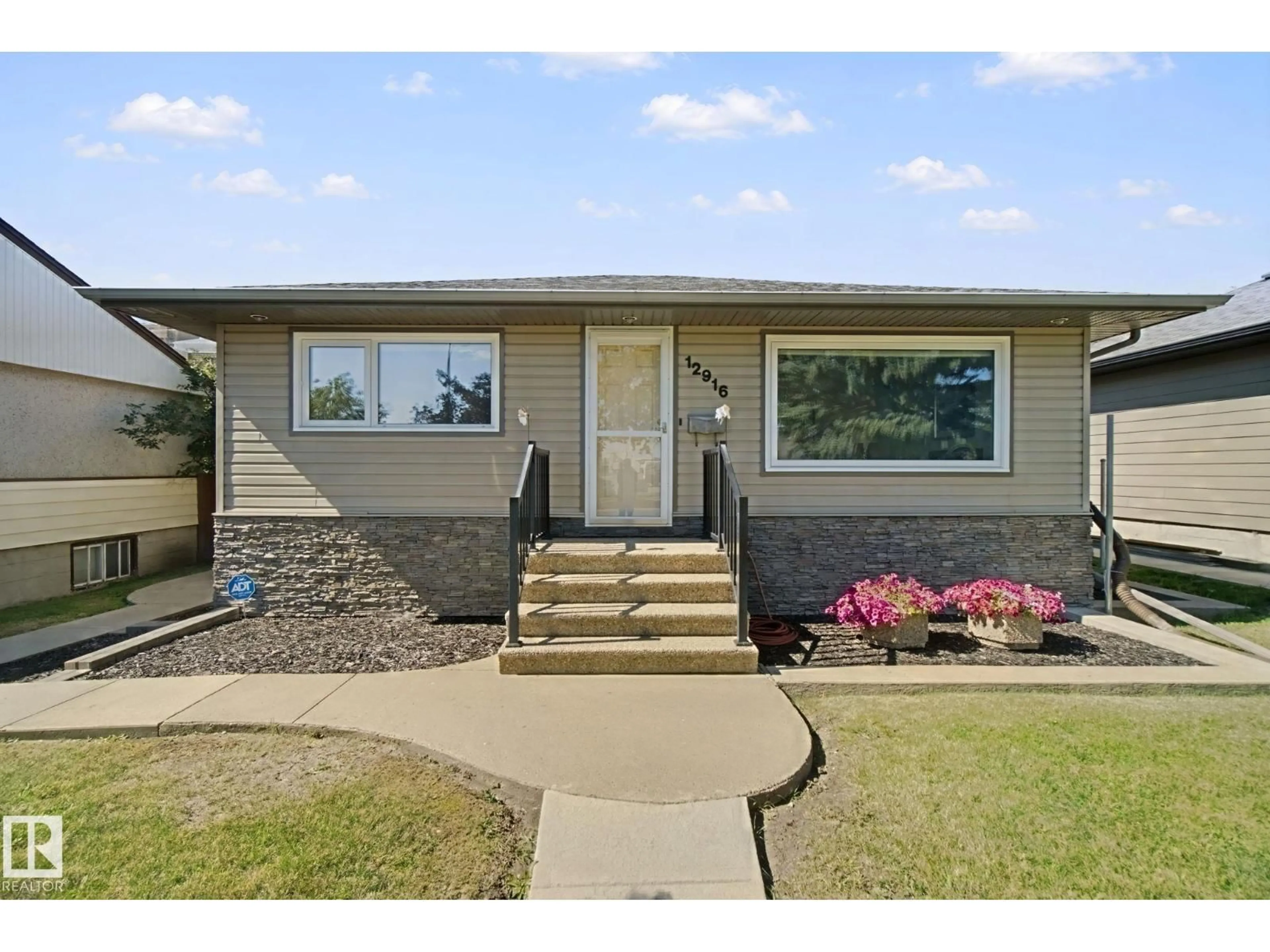 Home with vinyl exterior material, street for 12916 63 ST, Edmonton Alberta T5A0W3