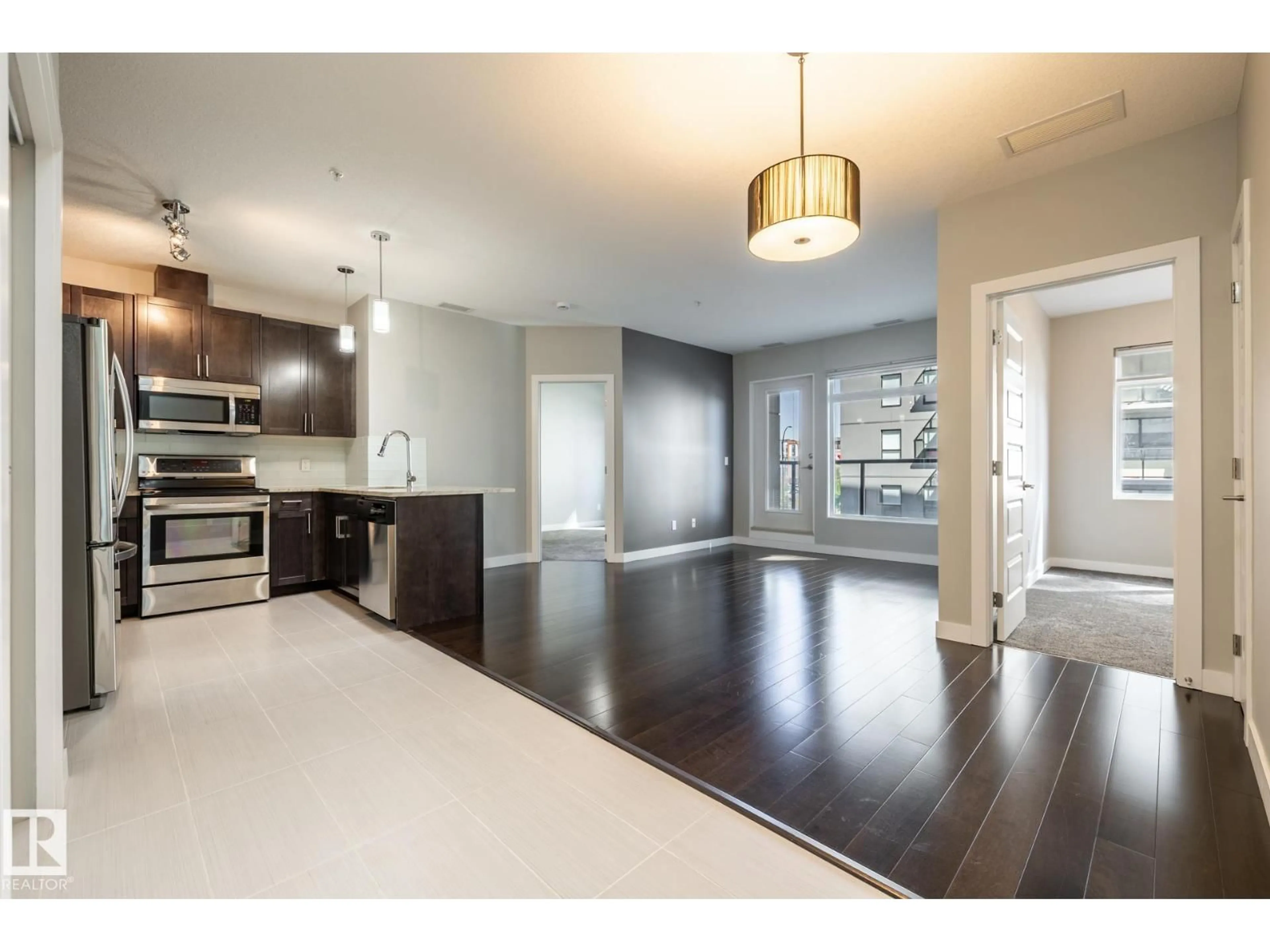 Open concept kitchen, wood/laminate floor for 312 - 5151 WINDERMERE BV, Edmonton Alberta T6W2K4