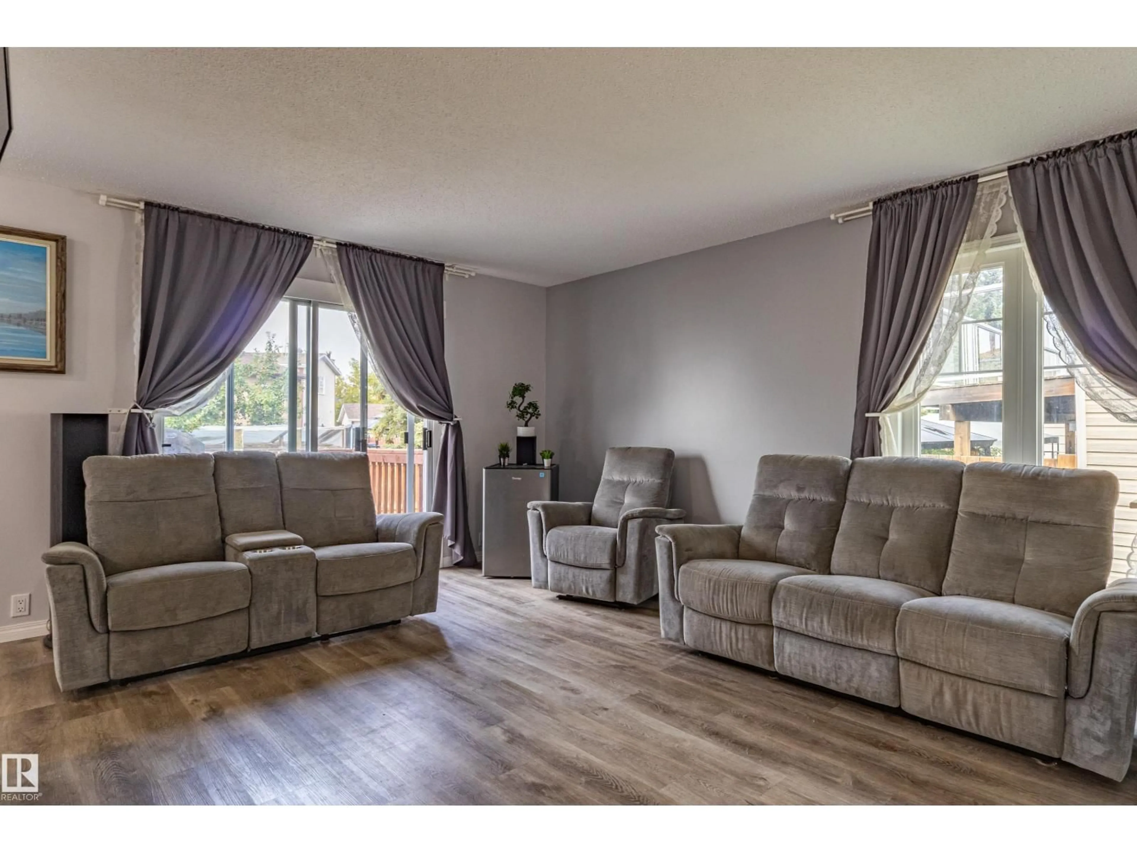 Living room with furniture, wood/laminate floor for 7408 180 STREET, Edmonton Alberta T5T2K8