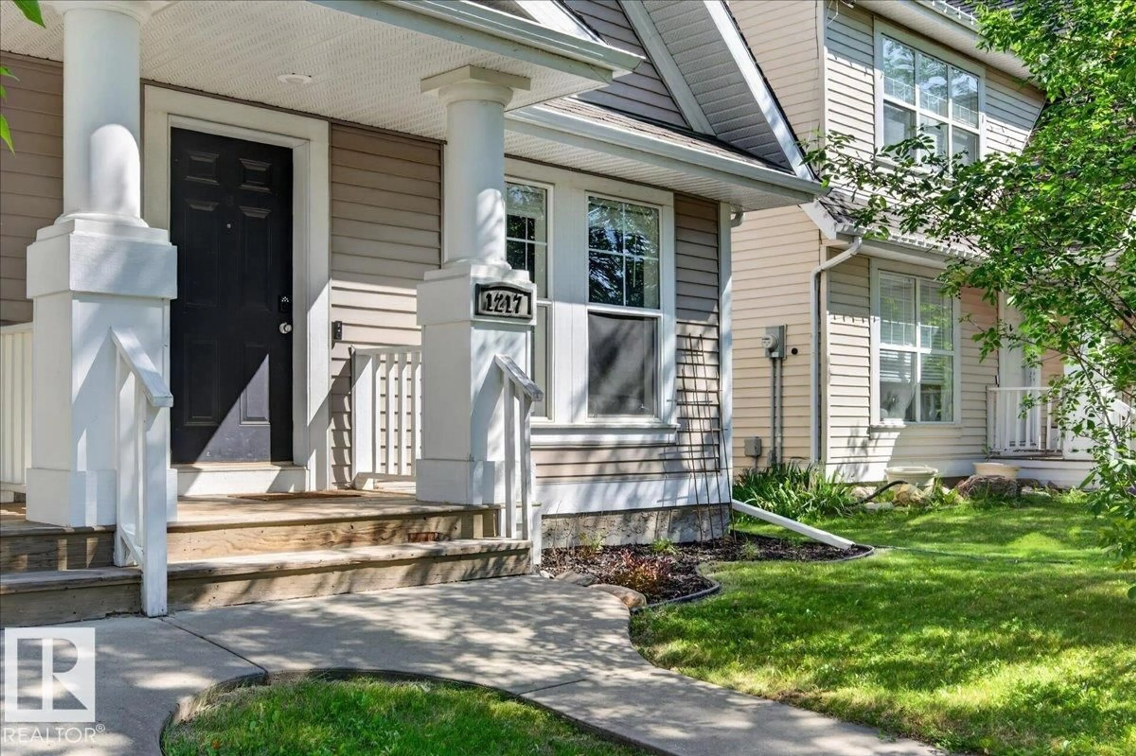 Home with vinyl exterior material, street for 1217 76 STREET, Edmonton Alberta T6X1M9