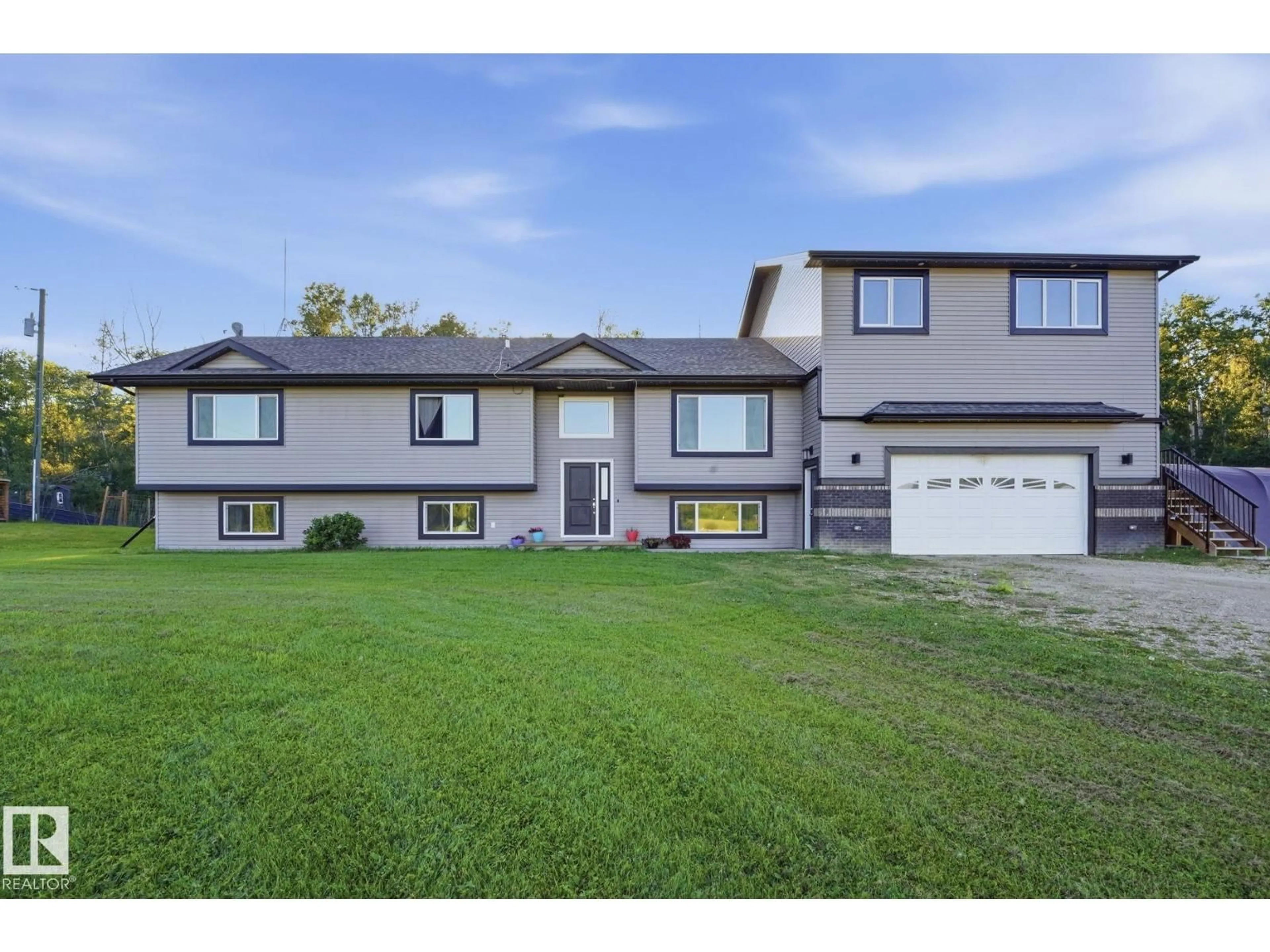 Home with vinyl exterior material, street for 54514 - 20 RGE ROAD 12, Rural Lac Ste. Anne County Alberta T0E1V2