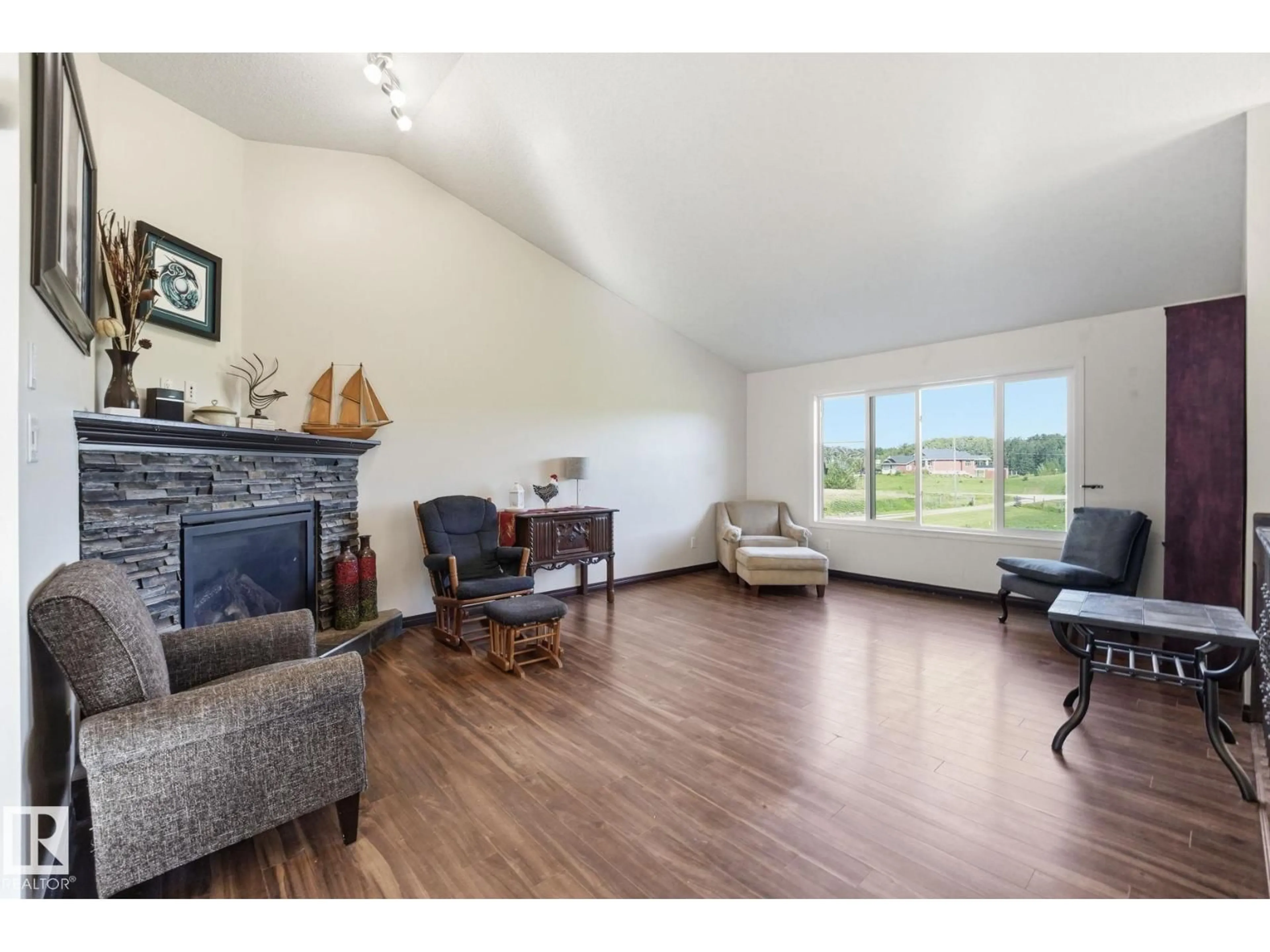 Living room with furniture, wood/laminate floor for 54514 - 20 RGE ROAD 12, Rural Lac Ste. Anne County Alberta T0E1V2