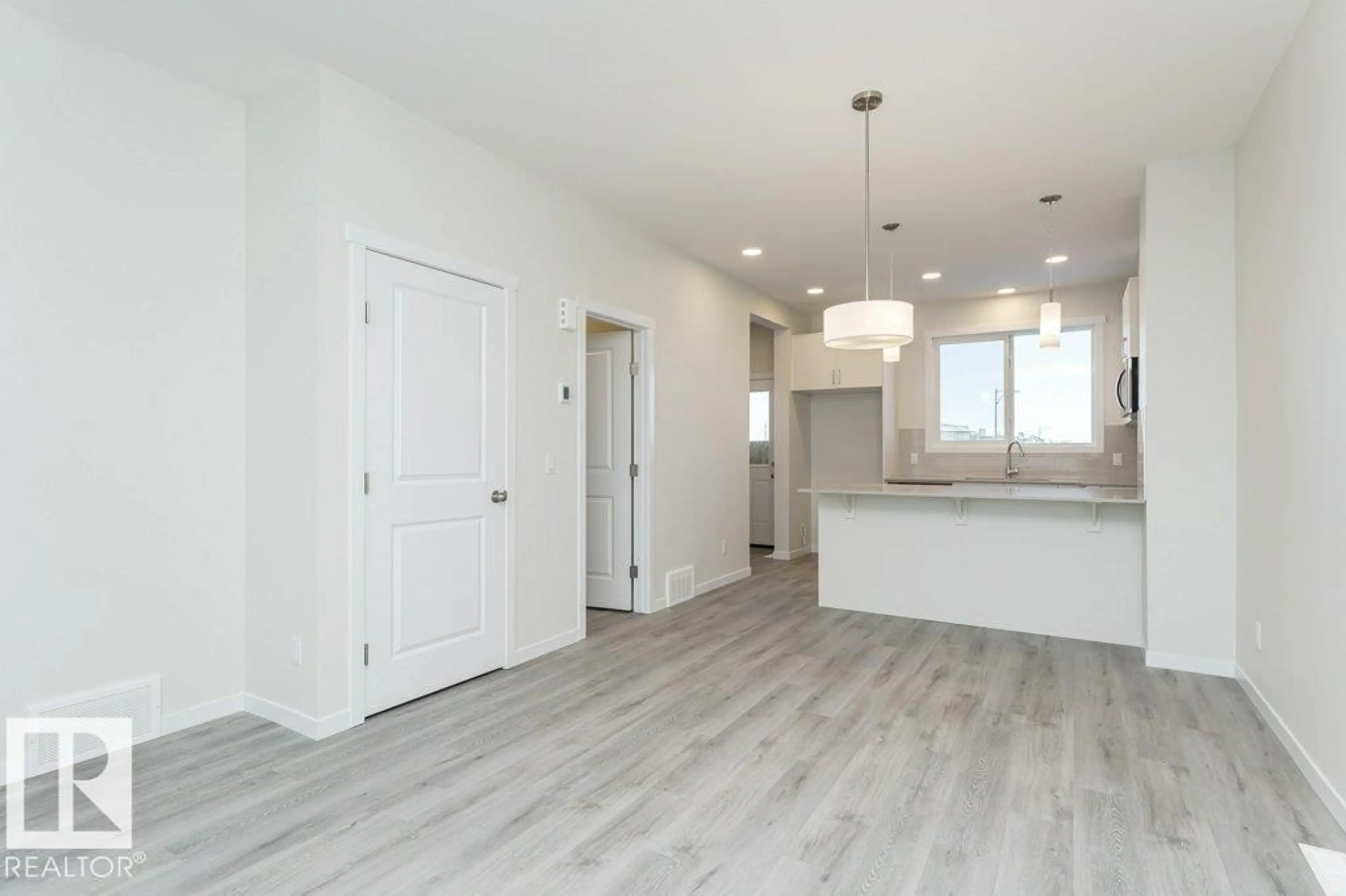 Open concept kitchen, wood/laminate floor for 6281 175A AV, Edmonton Alberta T5Y4A5
