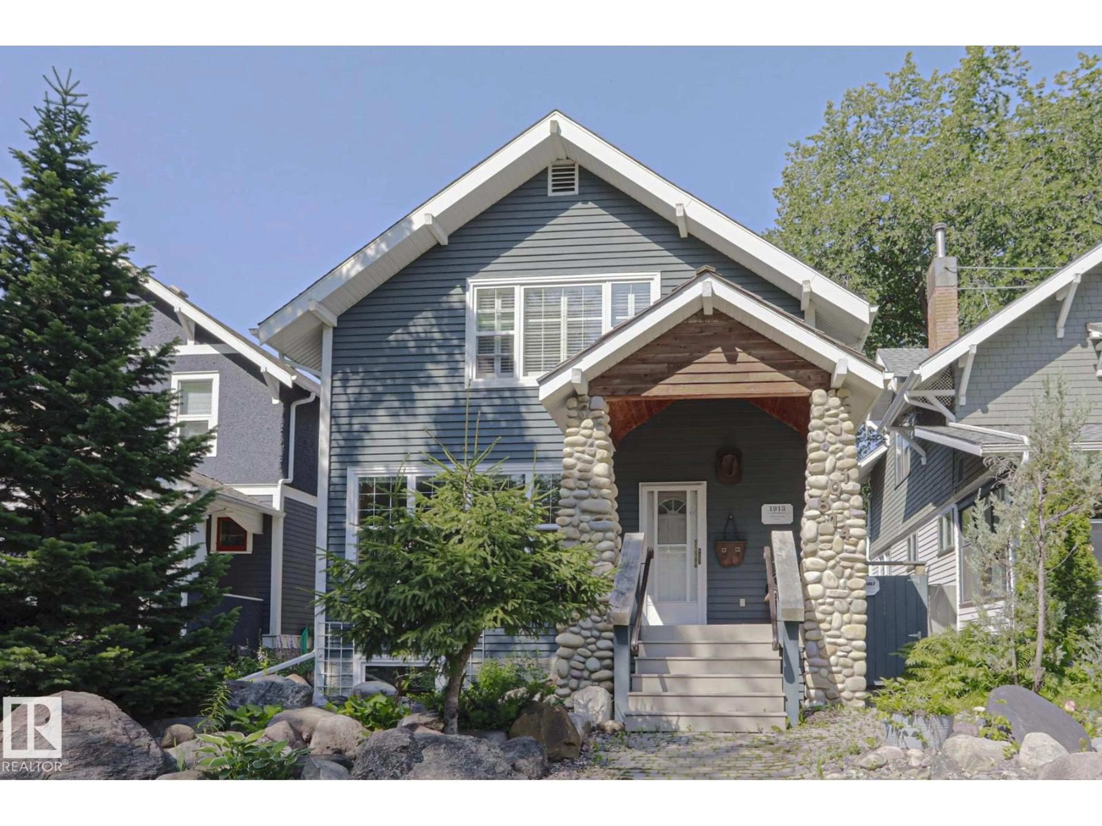 Home with vinyl exterior material, street for 10814 125 ST NW, Edmonton Alberta T5M0L4