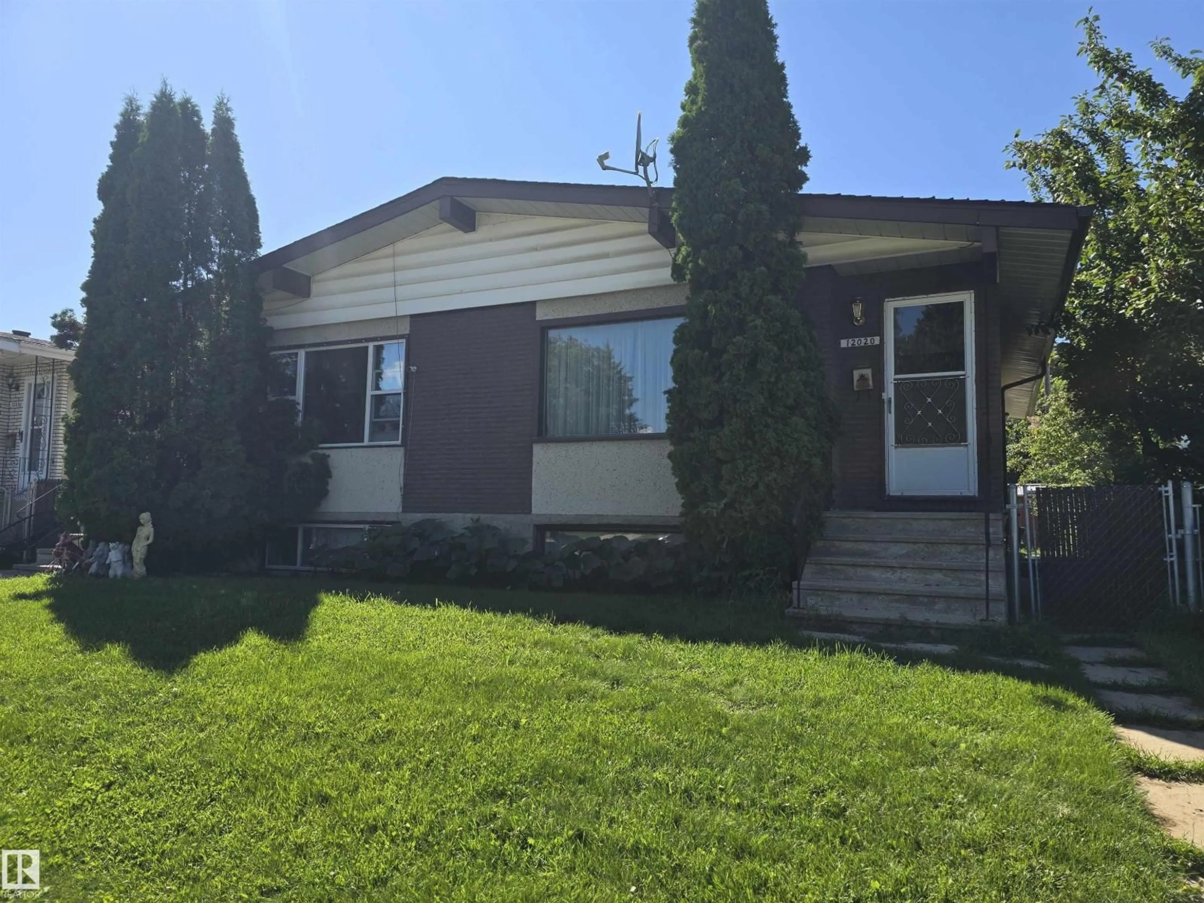 Home with vinyl exterior material, street for 12020 54 ST, Edmonton Alberta T5W3N3