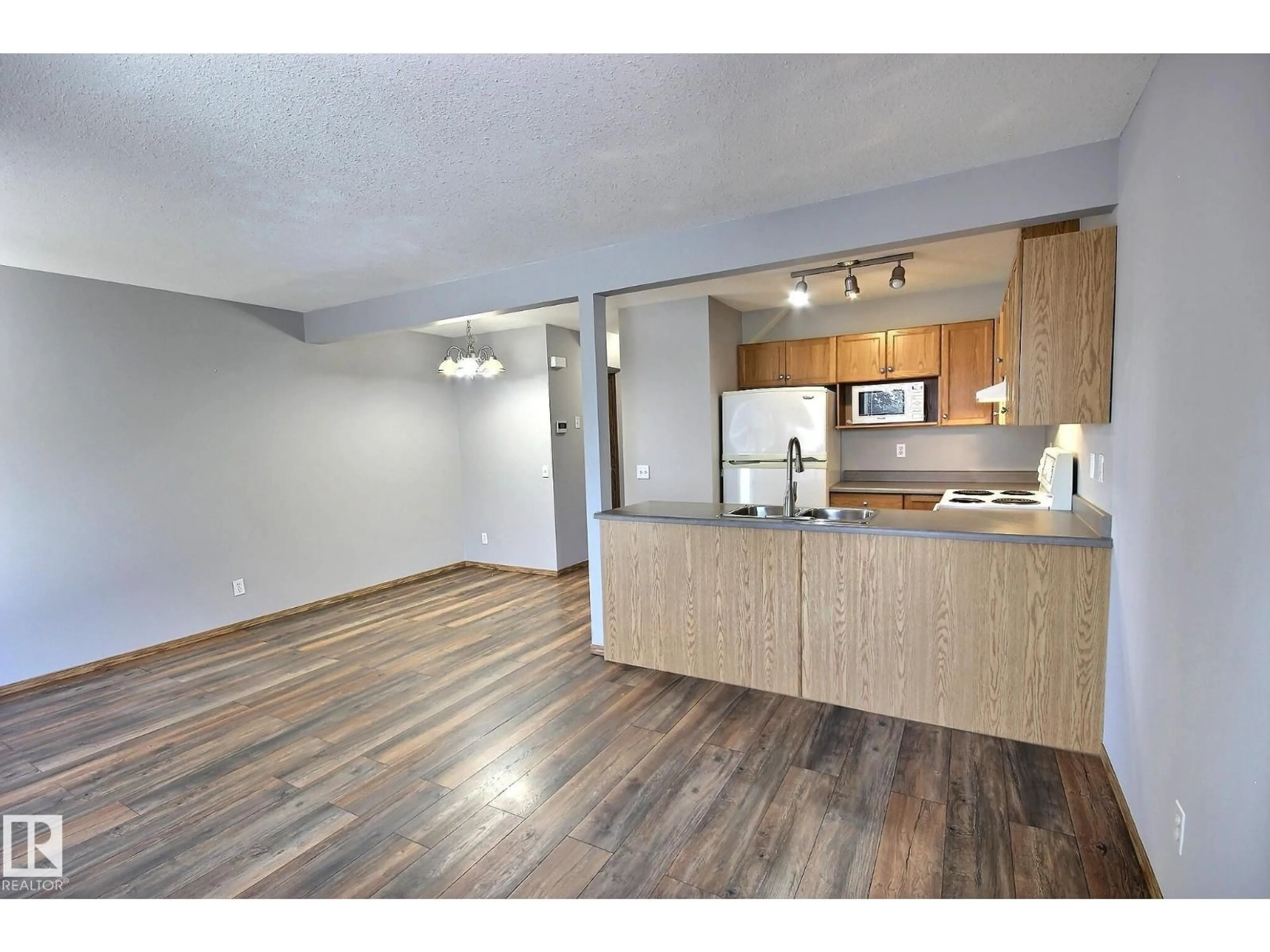 Open concept kitchen, wood/laminate floor for 53 16823 84 ST NW, Edmonton Alberta T5Z3S4