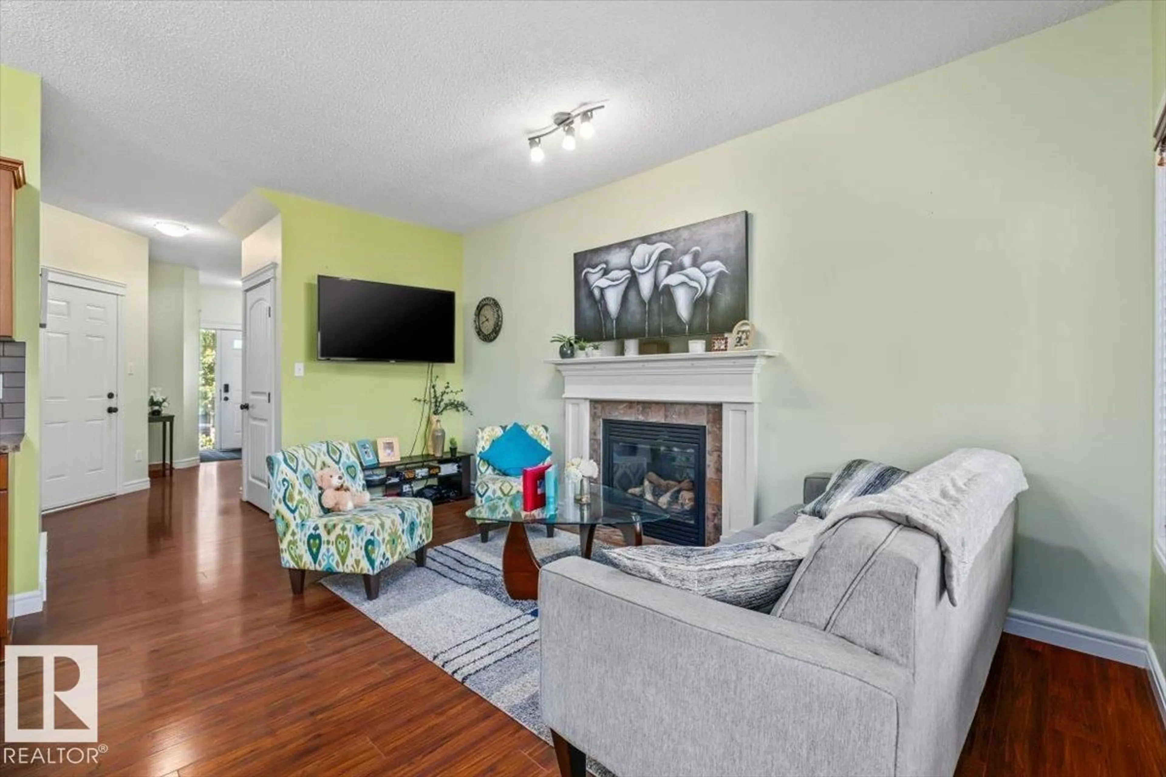 Living room with furniture, wood/laminate floor for 11506 17 AV, Edmonton Alberta T6W1Y4