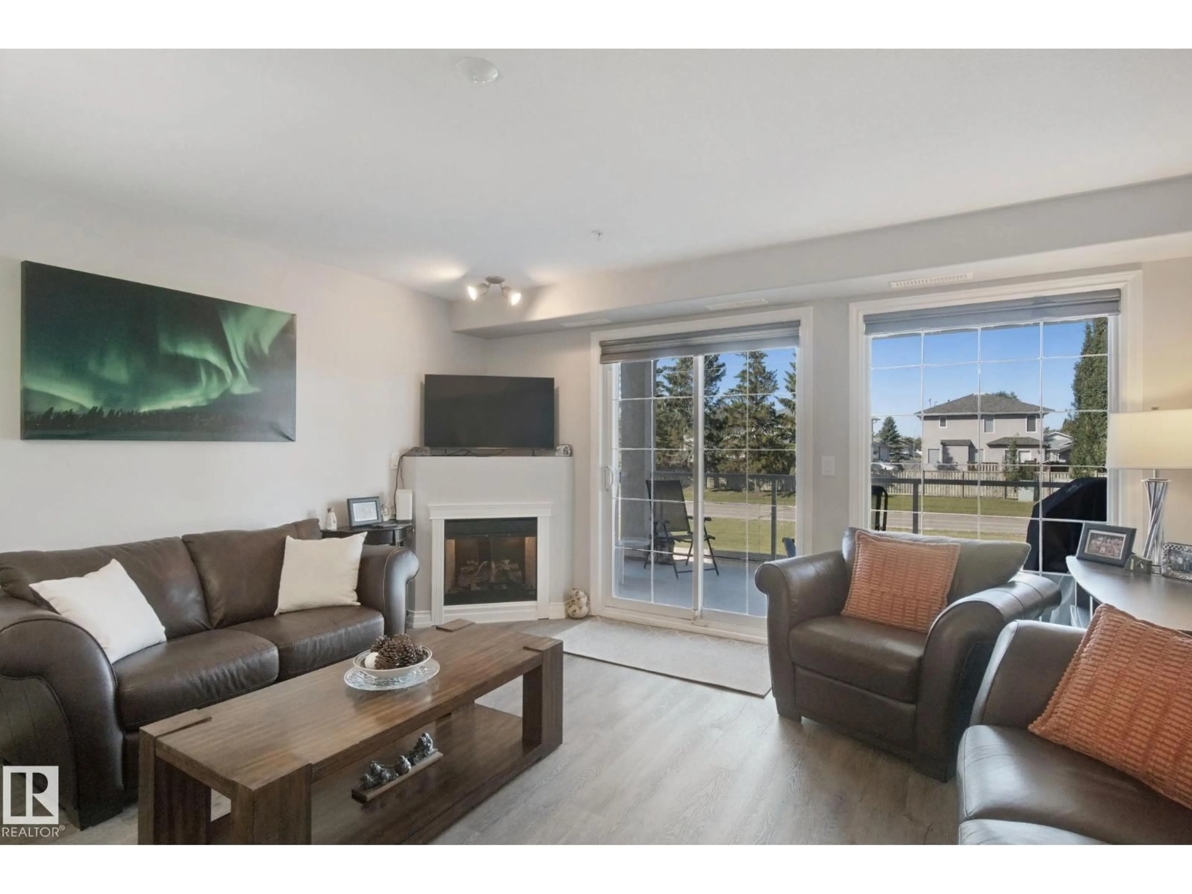 Living room with furniture, wood/laminate floor for 7801 - 218 GOLF COURSE RD, Stony Plain Alberta T7Z0C7