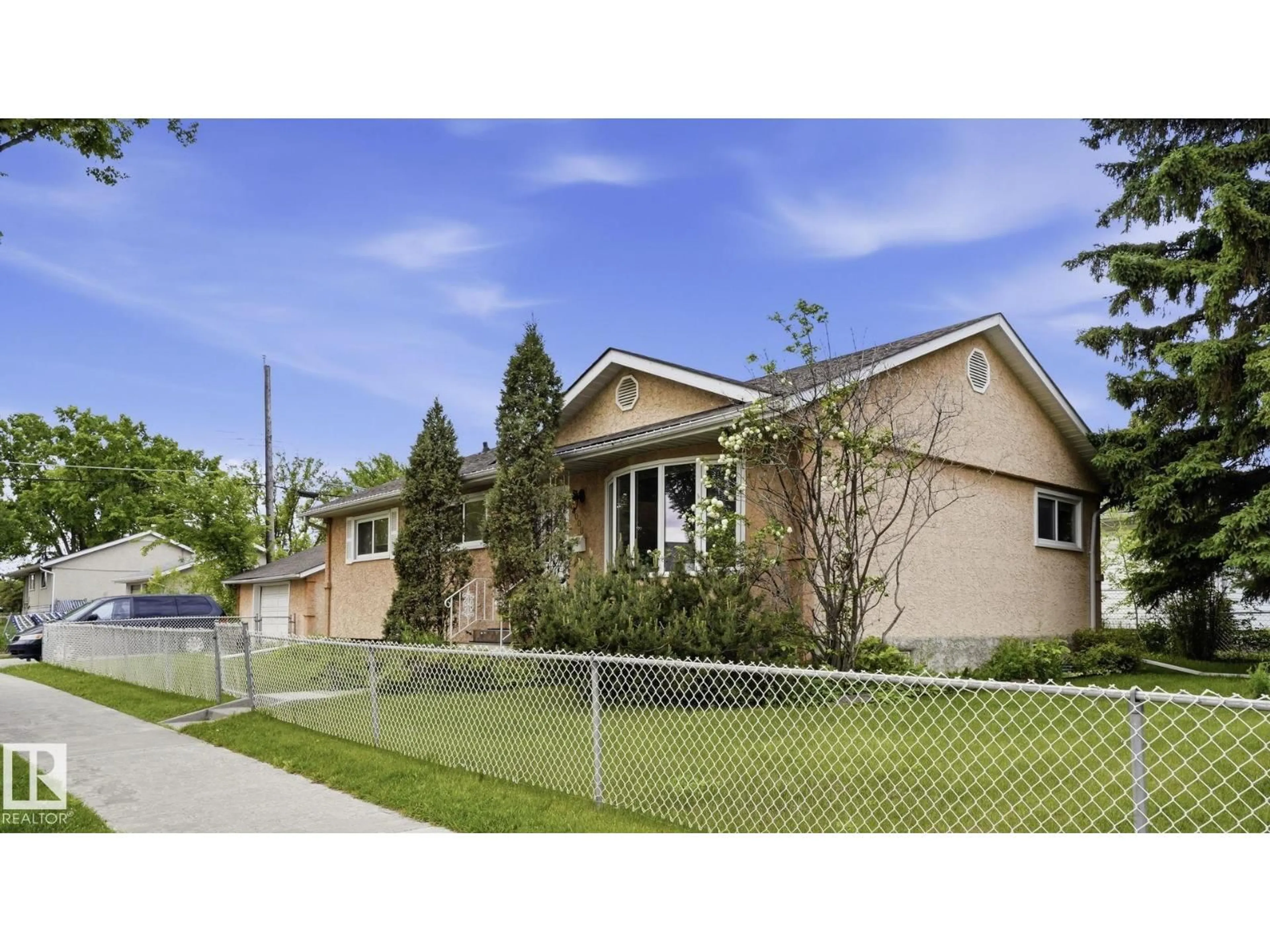 Home with vinyl exterior material, street for 13008 105 ST NW, Edmonton Alberta T5E4R9