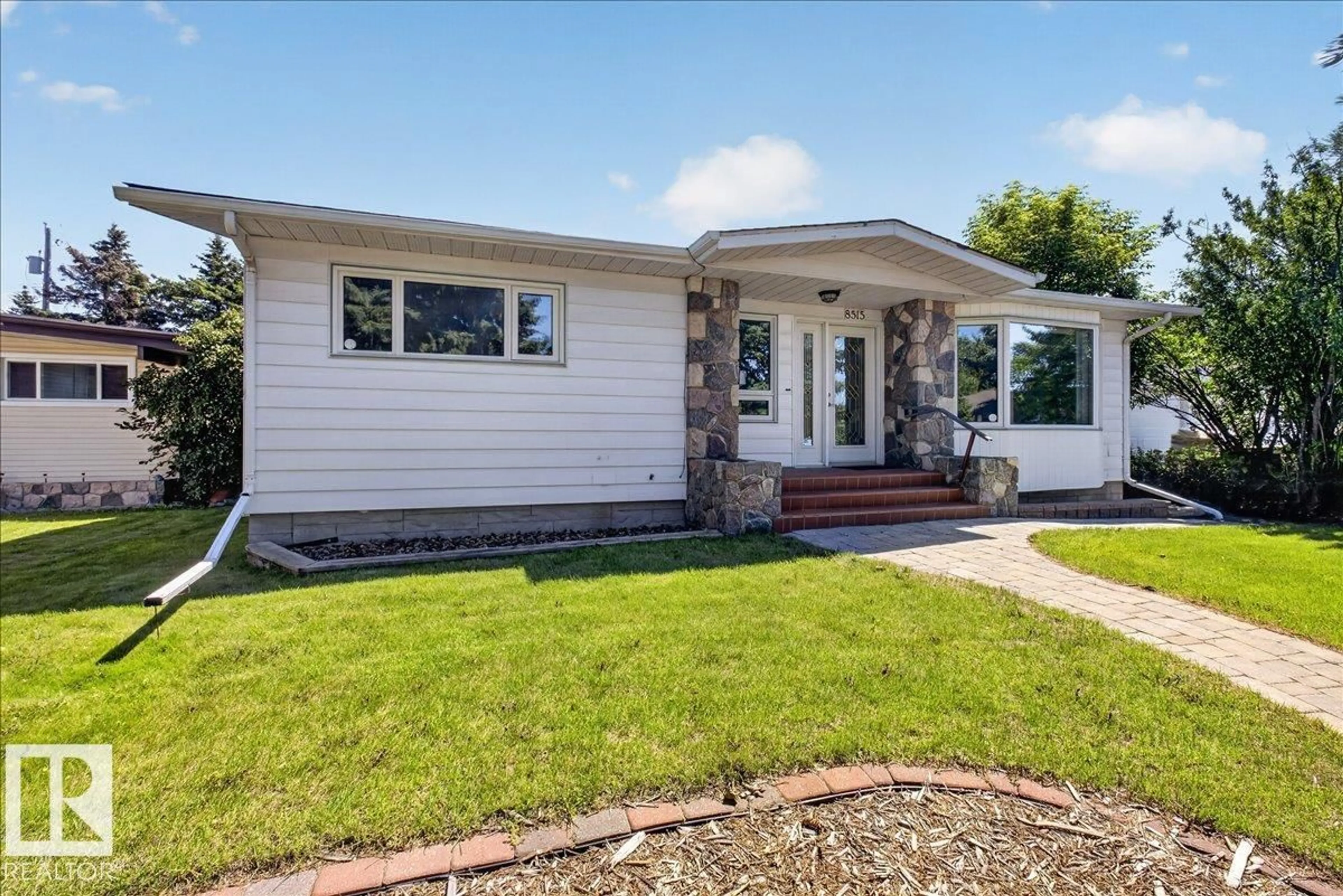 Home with vinyl exterior material, street for 8515 56 ST, Edmonton Alberta T6B1H8