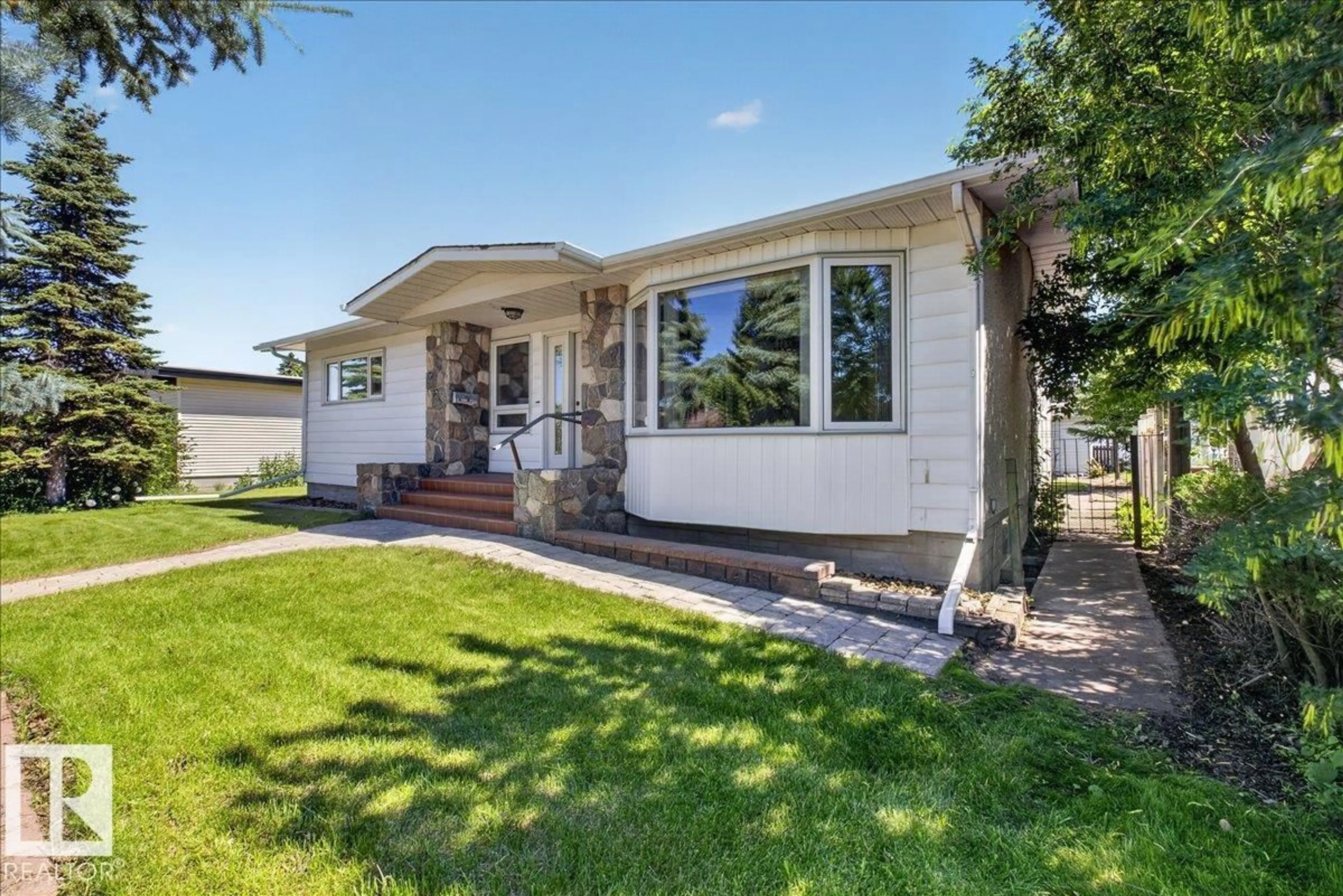 Home with vinyl exterior material, street for 8515 56 ST, Edmonton Alberta T6B1H8