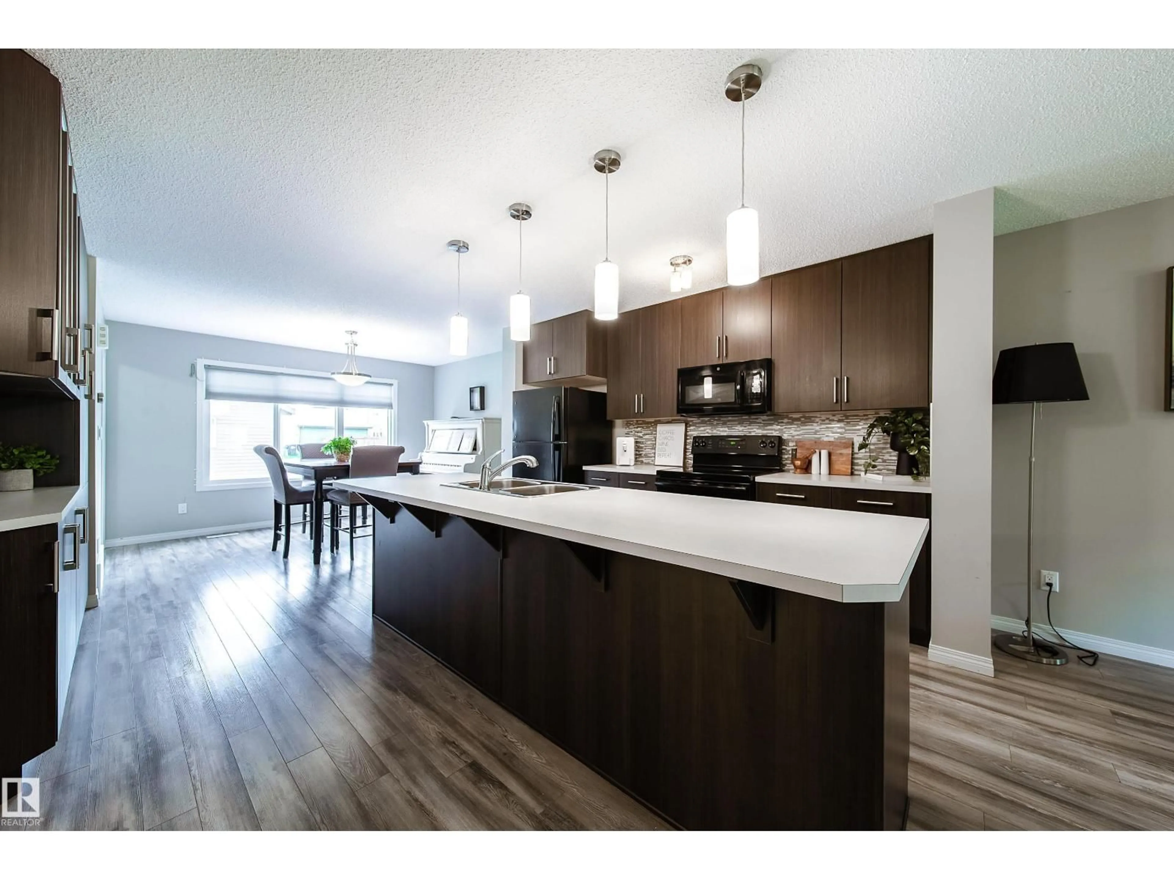Open concept kitchen, wood/laminate floor for SW - 3211 CHERRY CR, Edmonton Alberta T6X1Y5