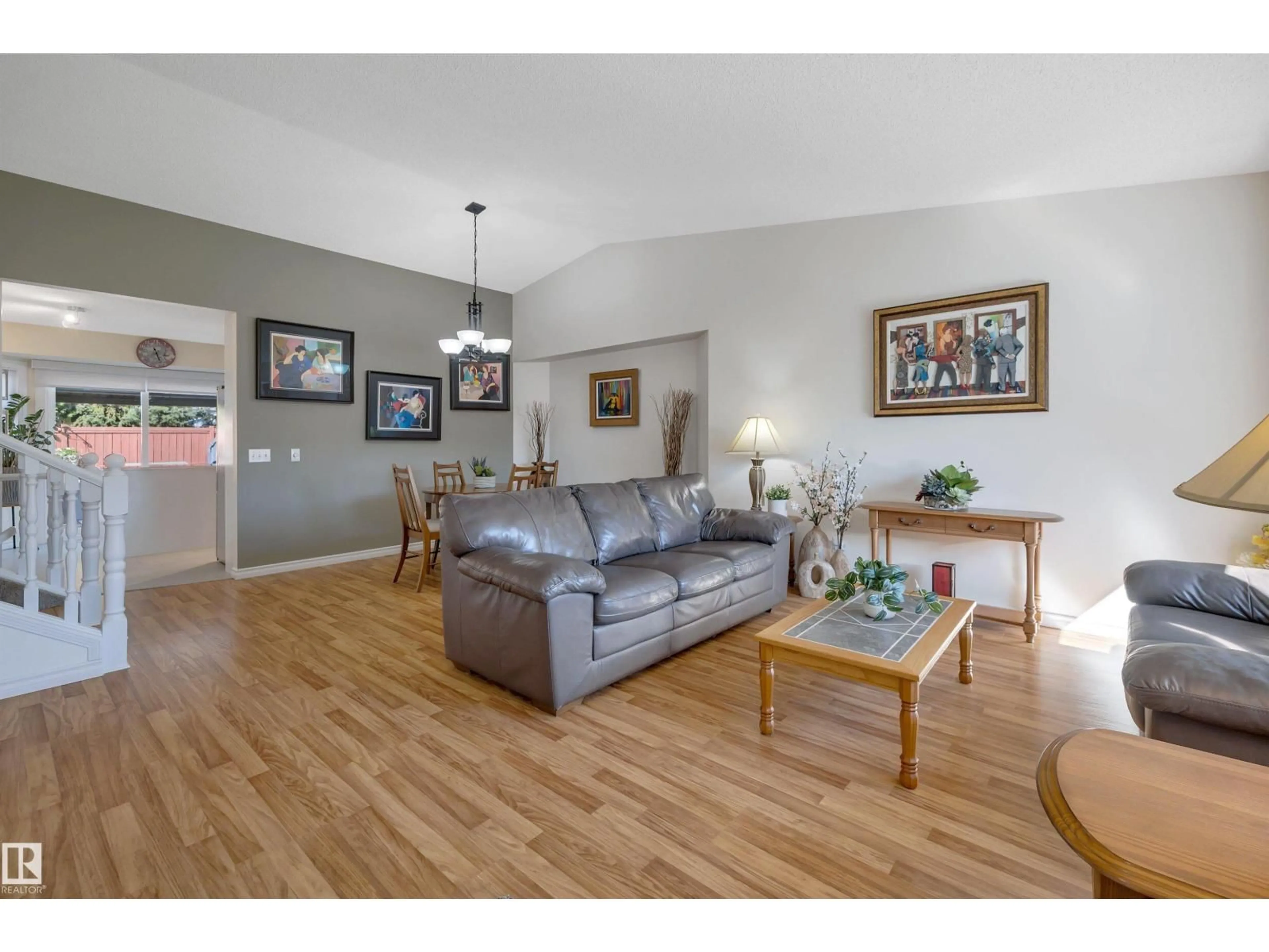 Living room with furniture, wood/laminate floor for 5735 152A AV, Edmonton Alberta T5A4X7