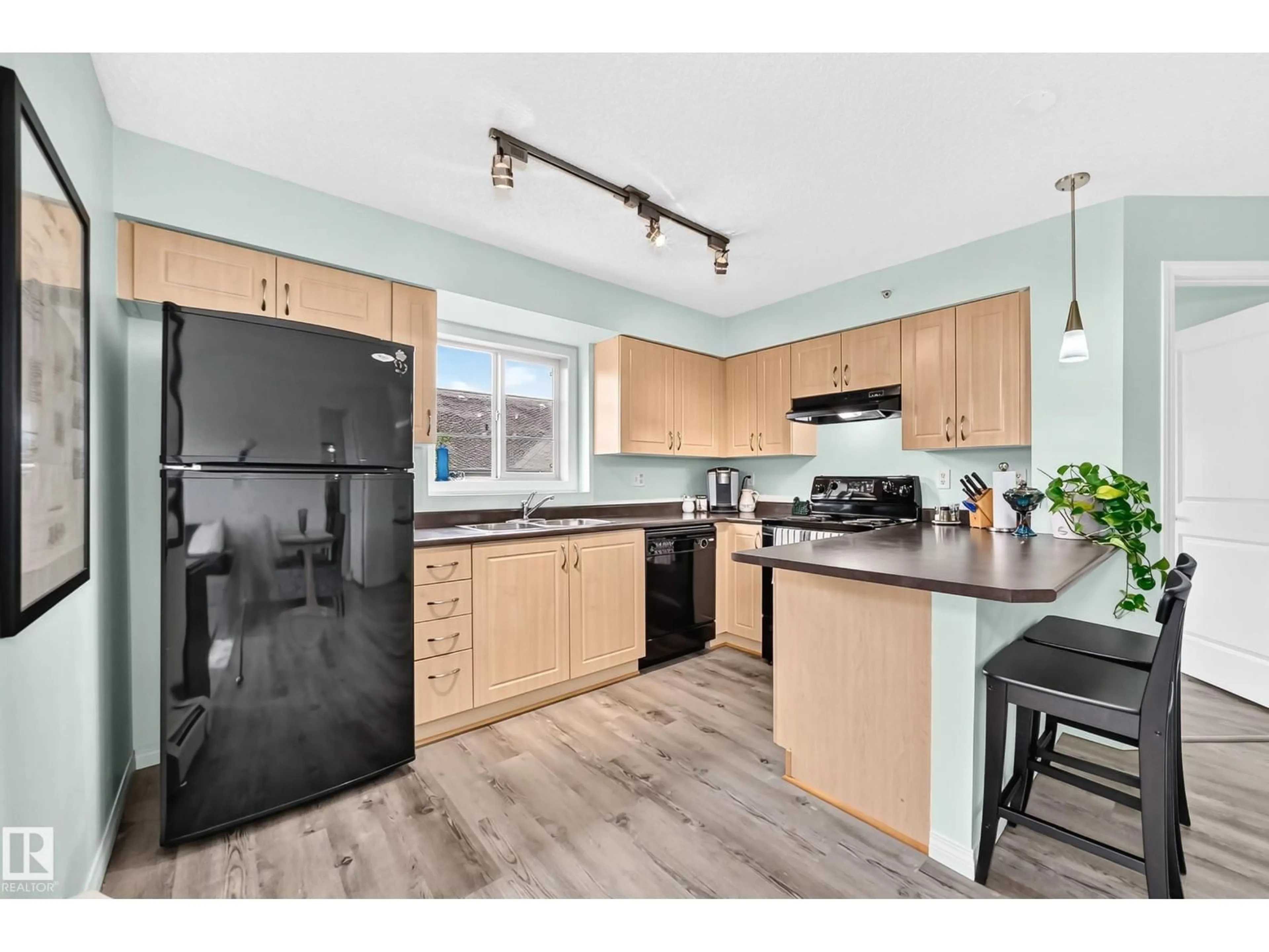Open concept kitchen, wood/laminate floor for #401 - 11449 ELLERSLIE RD, Edmonton Alberta T6W1T2