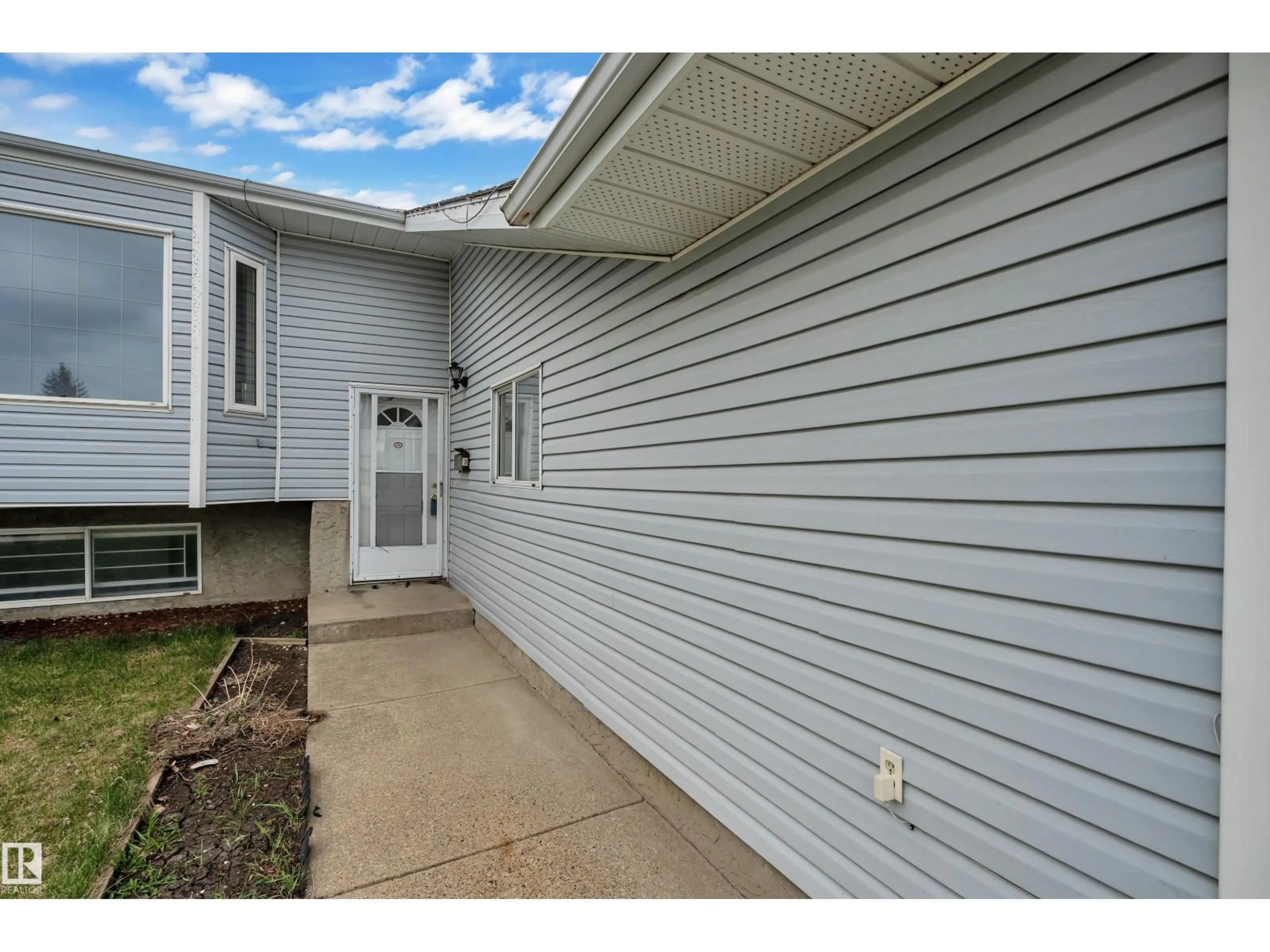 Home with vinyl exterior material, street for NW - 3227 145 AV, Edmonton Alberta T5Y2E9