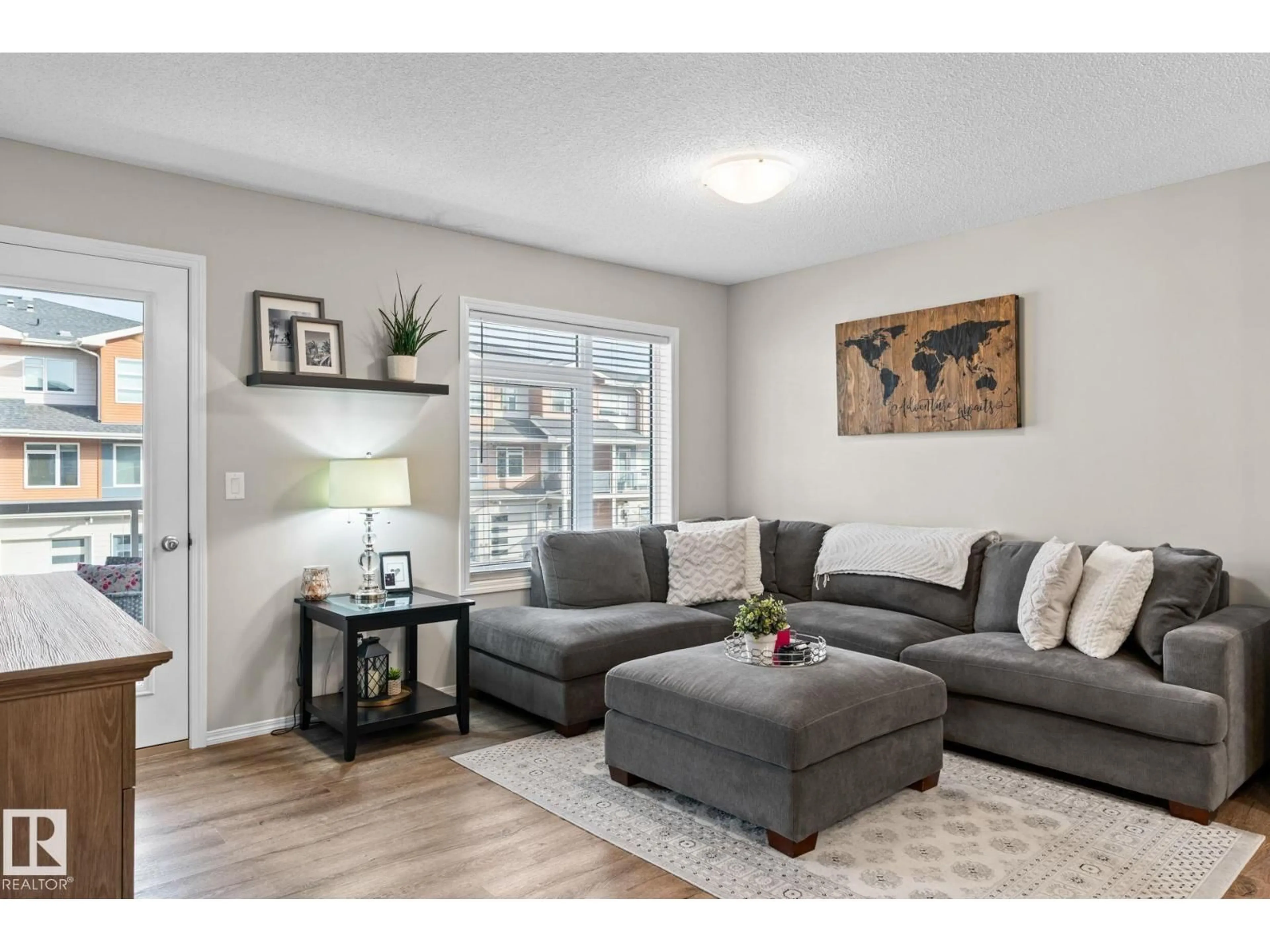 Living room with furniture, wood/laminate floor for 17253 9A AV, Edmonton Alberta T6W3V5
