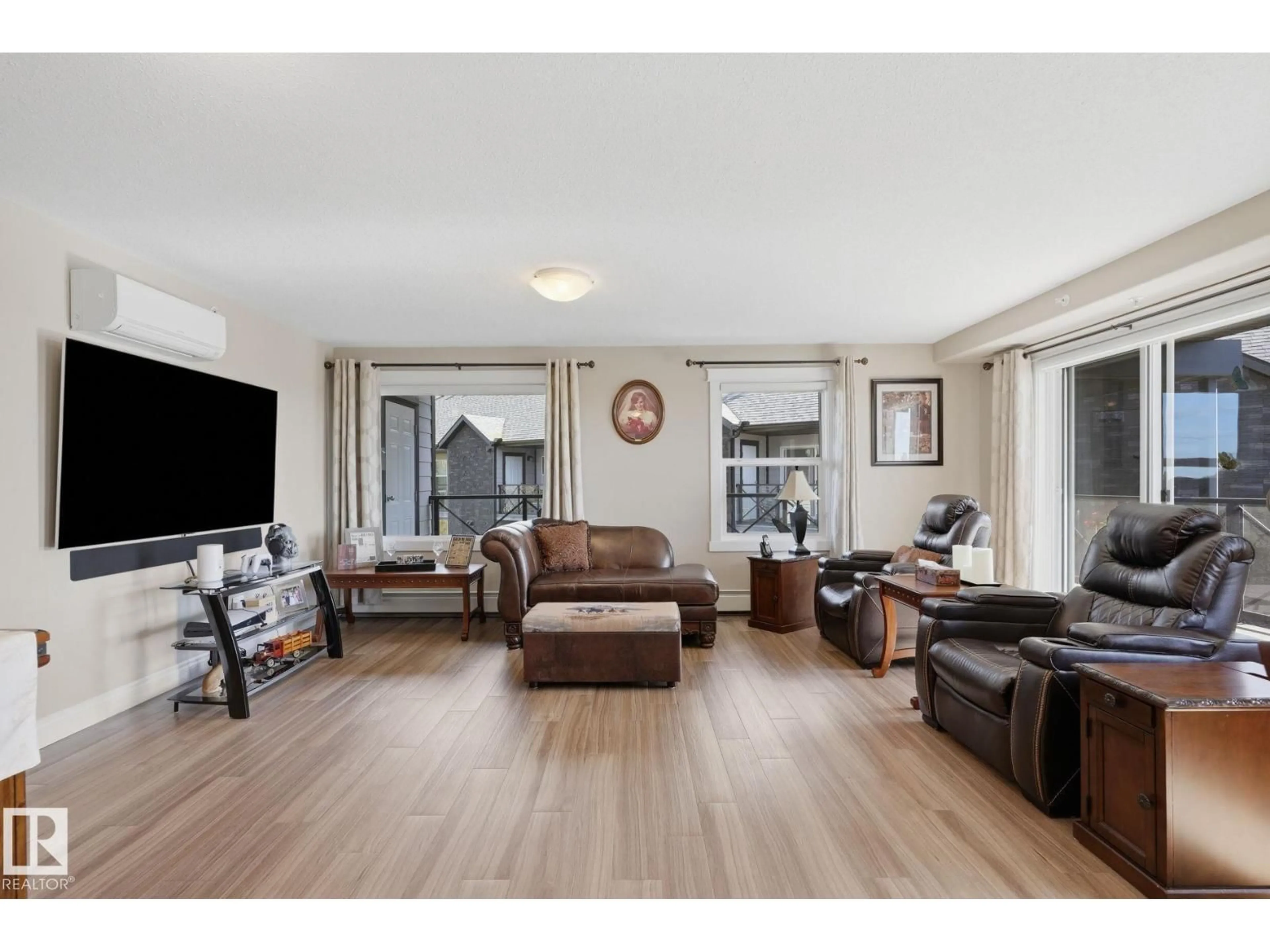 Living room with furniture, wood/laminate floor for #408 - 4103 50 ST, Beaumont Alberta T4X2C7