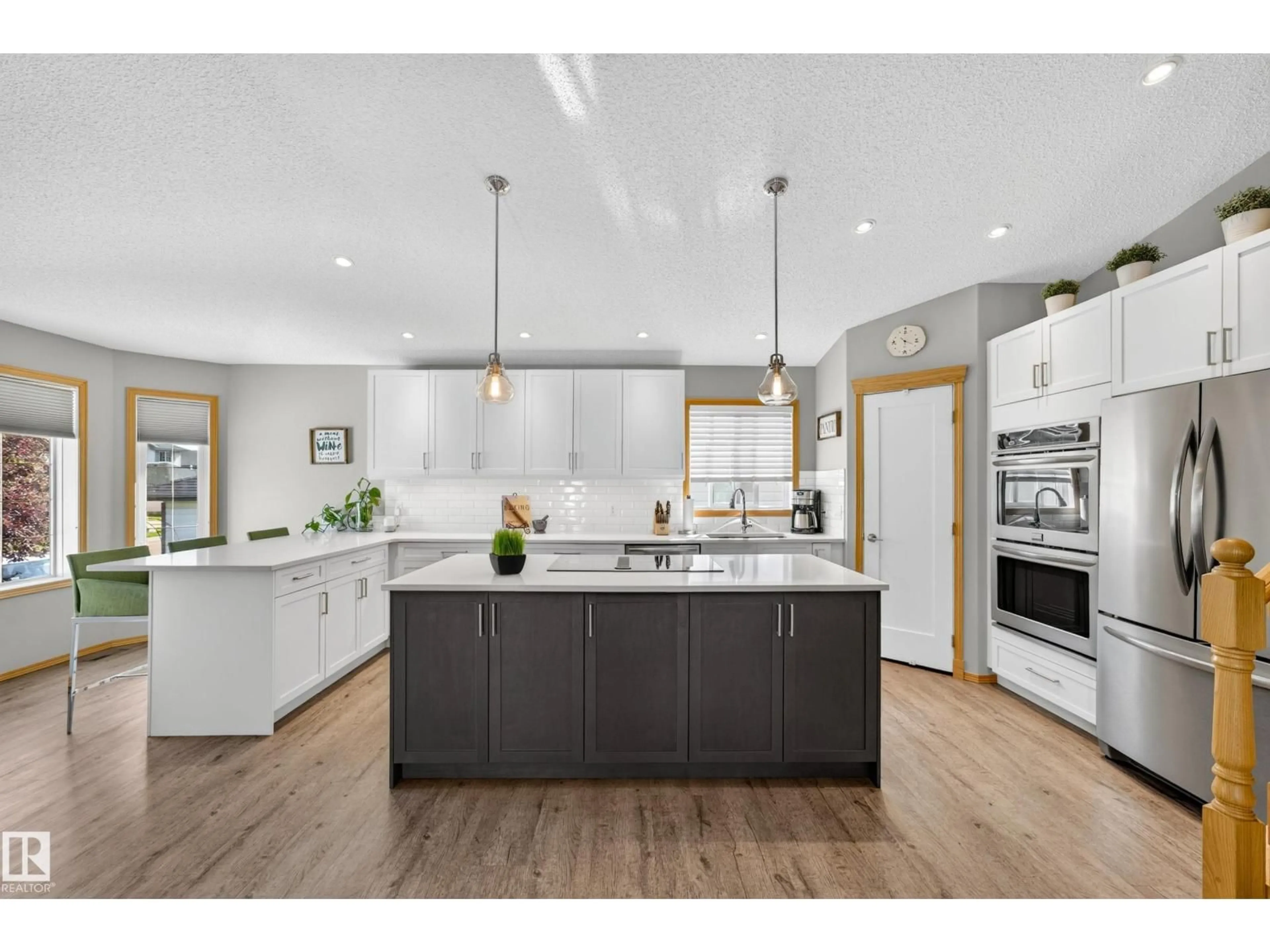 Open concept kitchen, wood/laminate floor for 8329 171A AV, Edmonton Alberta T5Z3E4