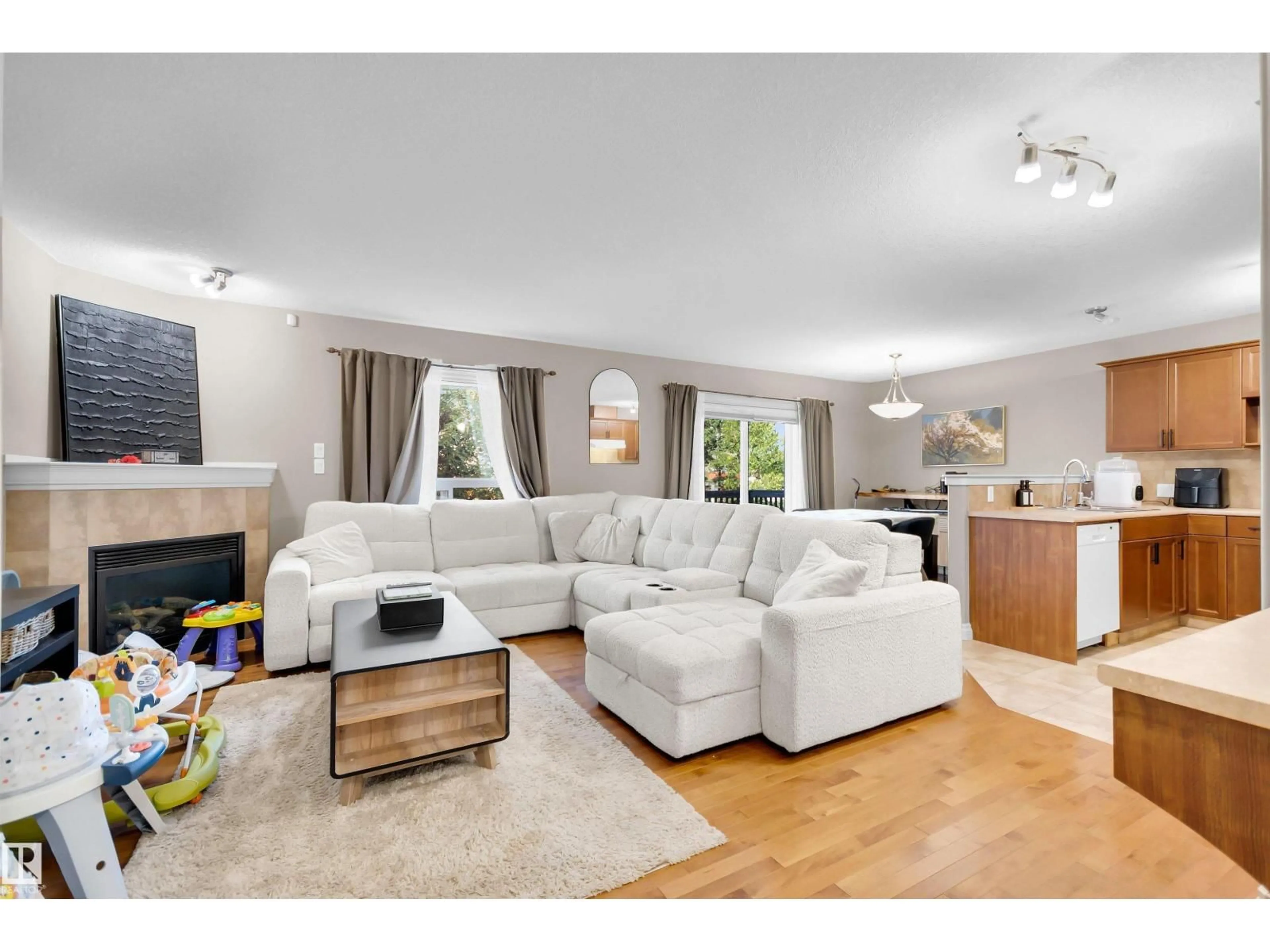 Living room with furniture, wood/laminate floor for 5 - 5120 164 AV, Edmonton Alberta T5Y0L7