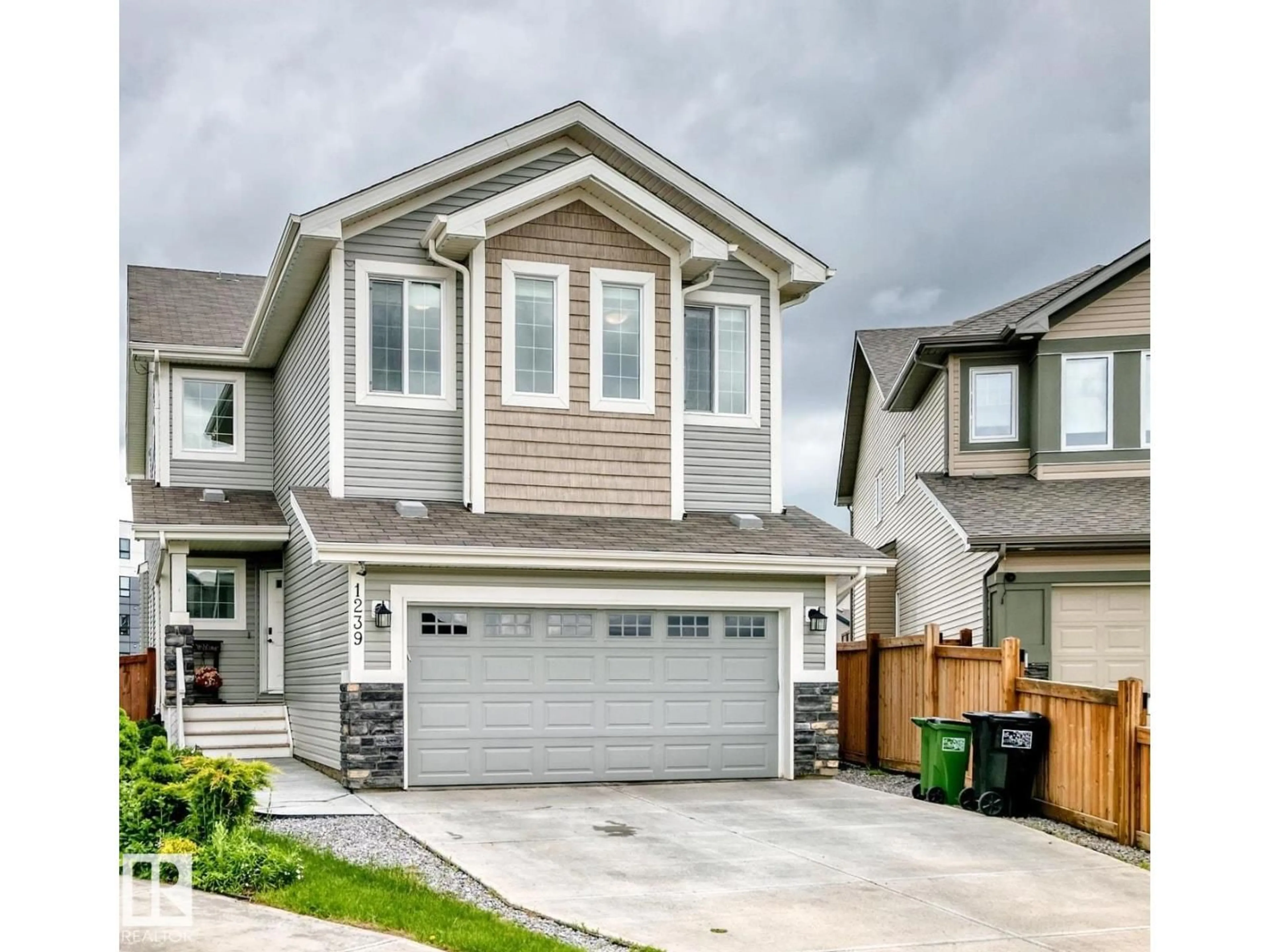 Home with vinyl exterior material, street for 1239 24 AV, Edmonton Alberta T6T2E4