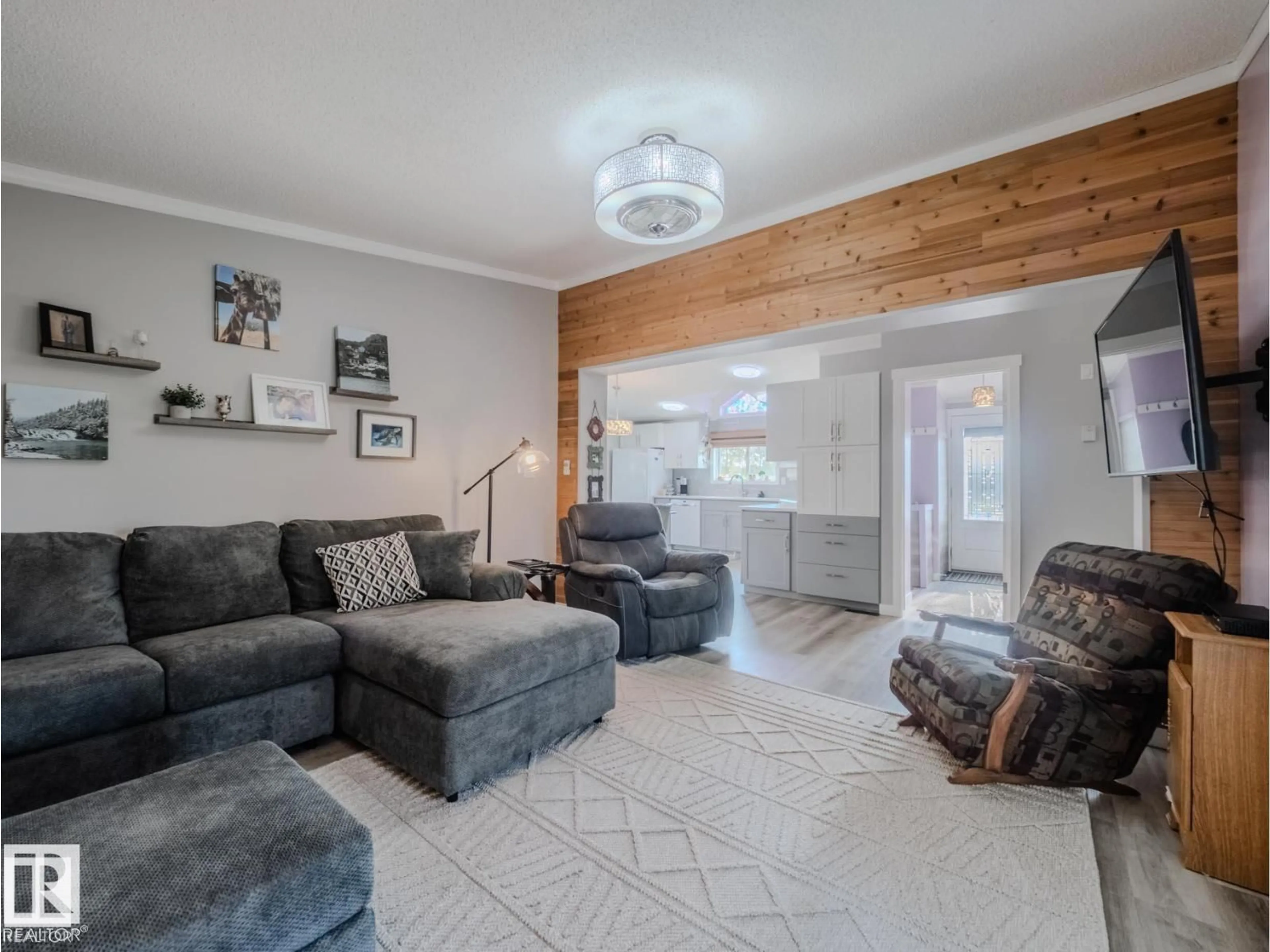 Living room with furniture, wood/laminate floor for B - 23021 TWP ROAD 502, Rural Leduc County Alberta T0B3M1