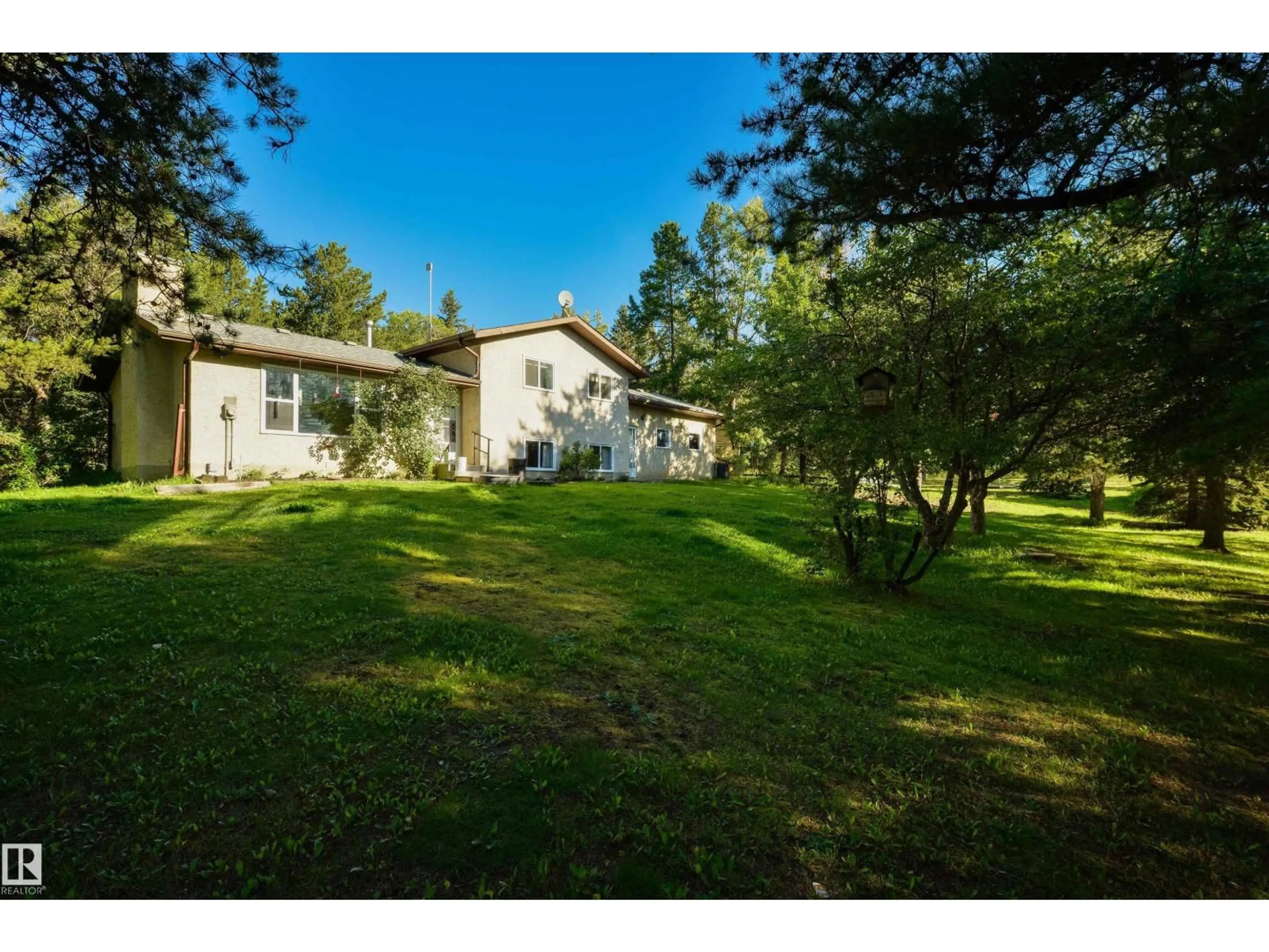 A pic from outside/outdoor area/front of a property/back of a property/a pic from drone, forest/trees view for 4 - 2103 TWP ROAD 525 B, Rural Parkland County Alberta T7Y2L4