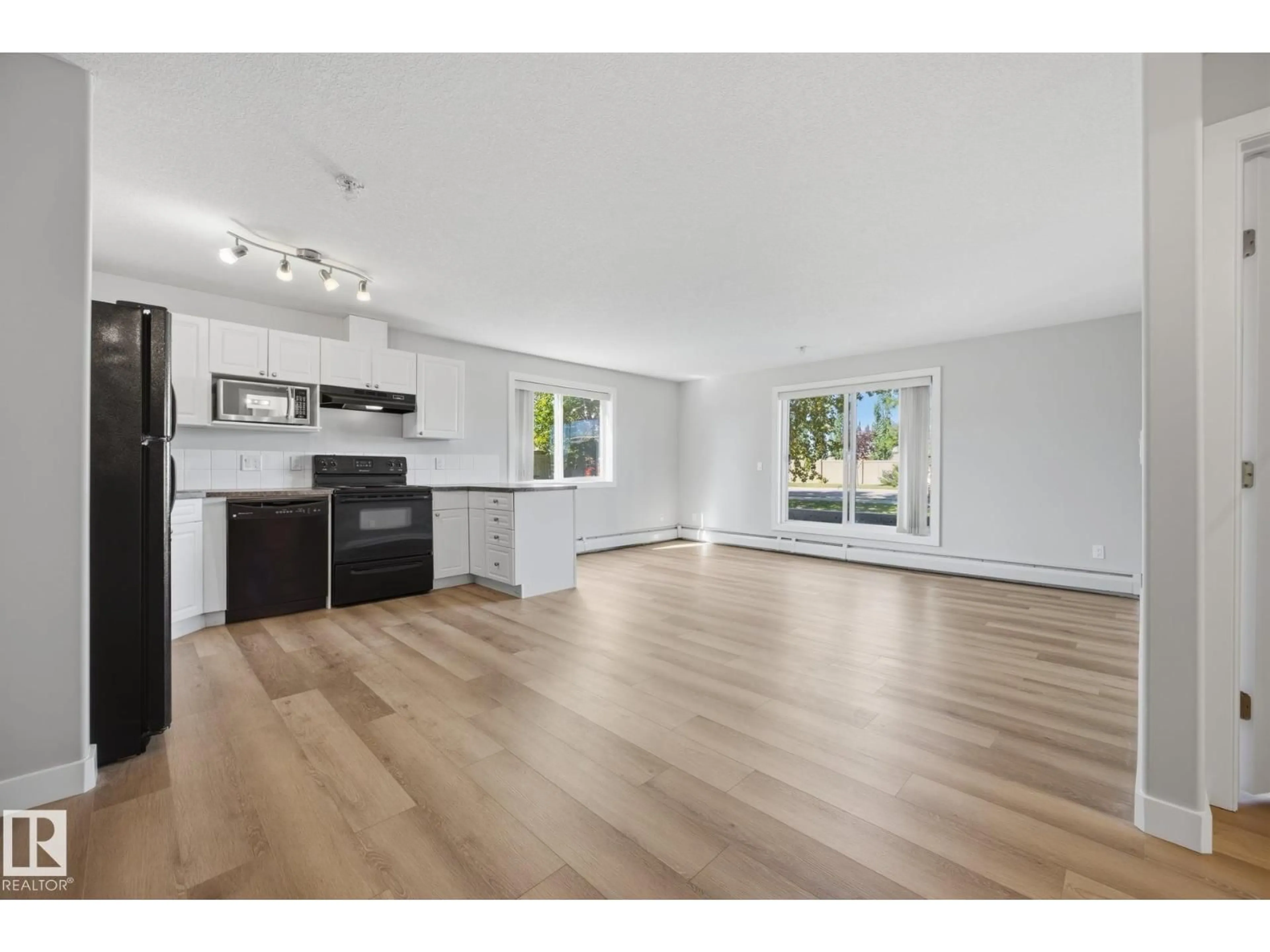 Open concept kitchen, wood/laminate floor for 122 240 SPRUCE RIDGE RD, Spruce Grove Alberta T5Y2N2