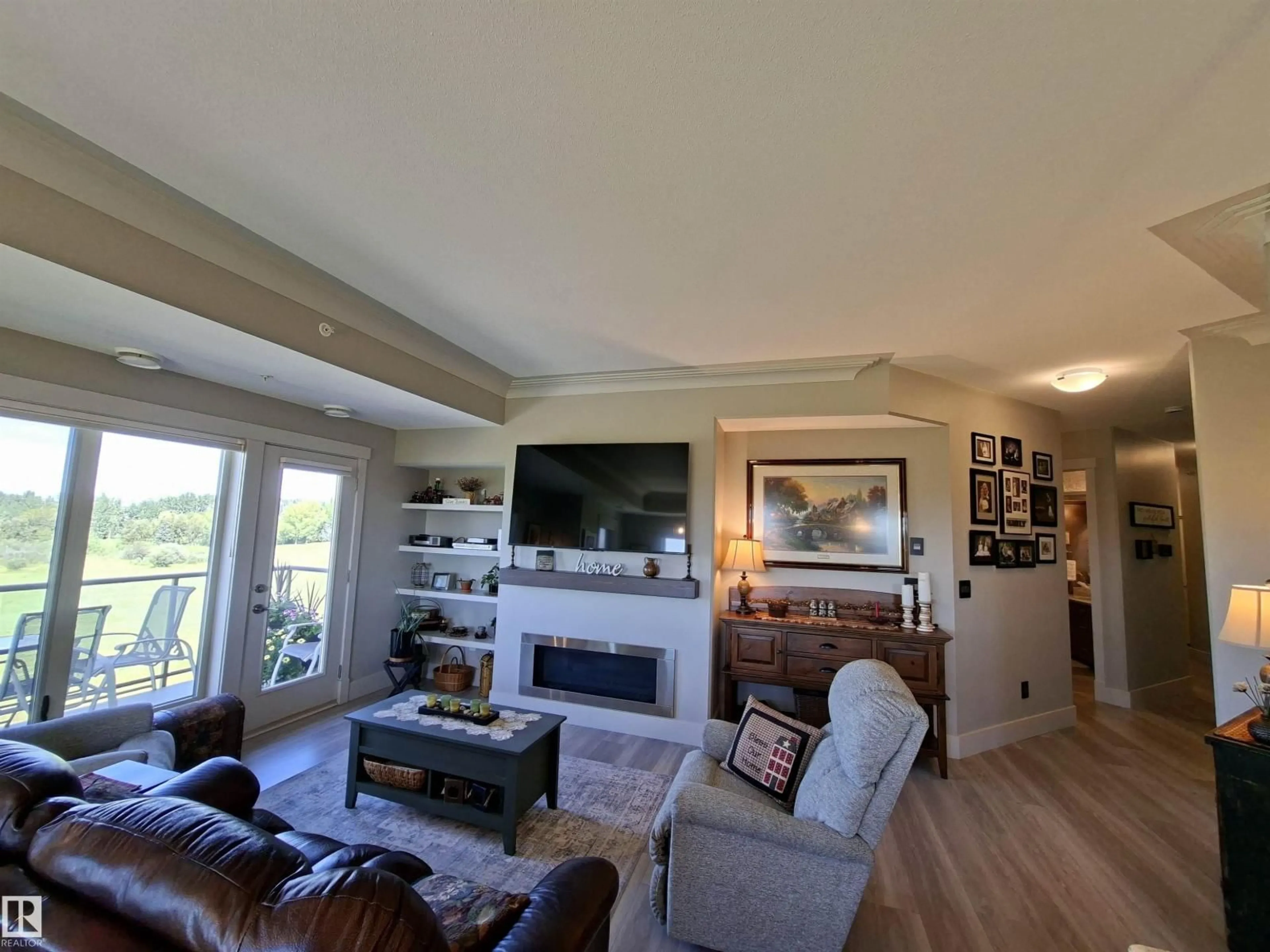 Living room with furniture, wood/laminate floor for #401 - 5201 BROUGHTAM DR, Drayton Valley Alberta T7A0C8